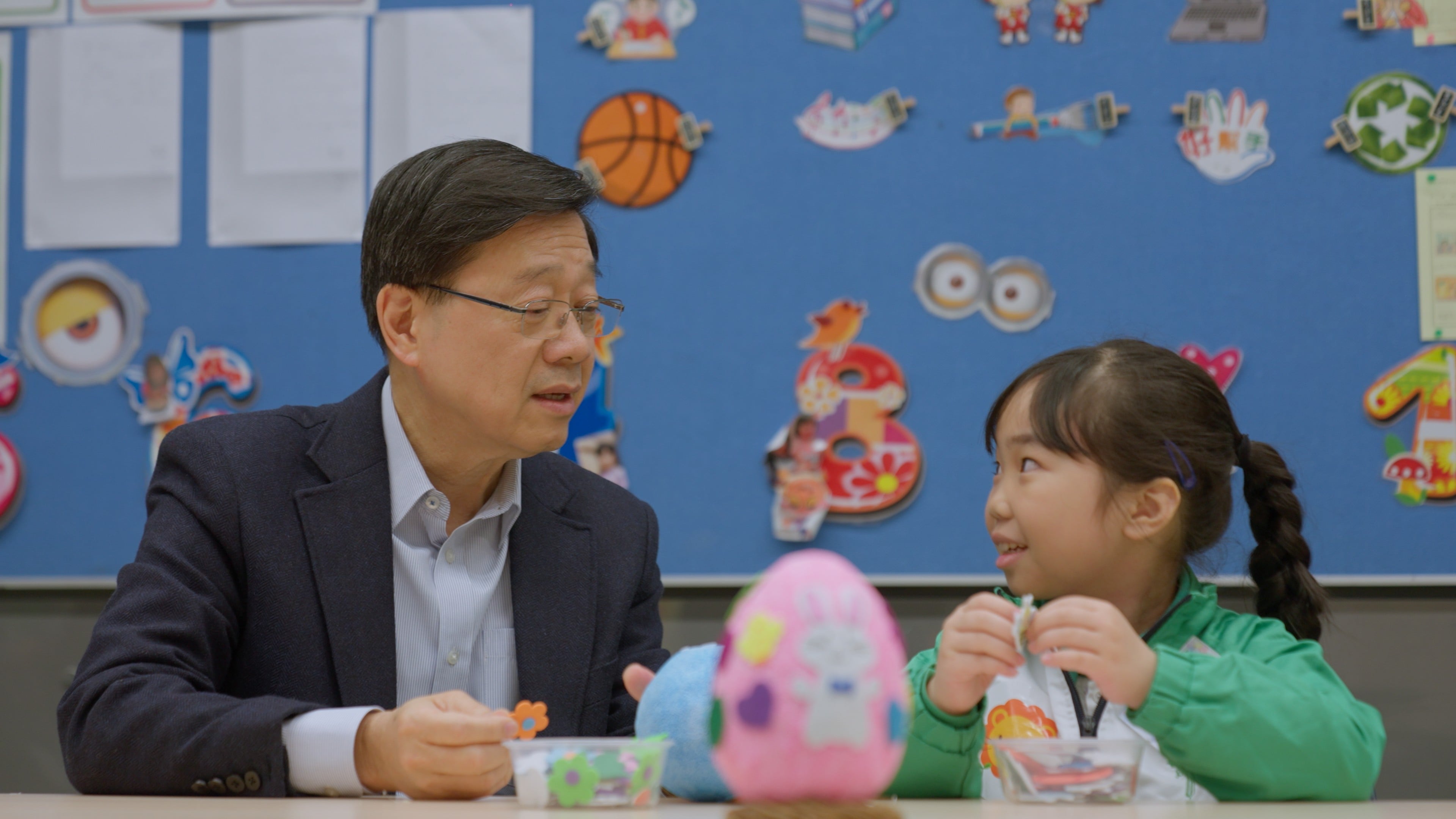 Chief Executive John Lee speaks to a pupil during a school visit. Photo: Handout