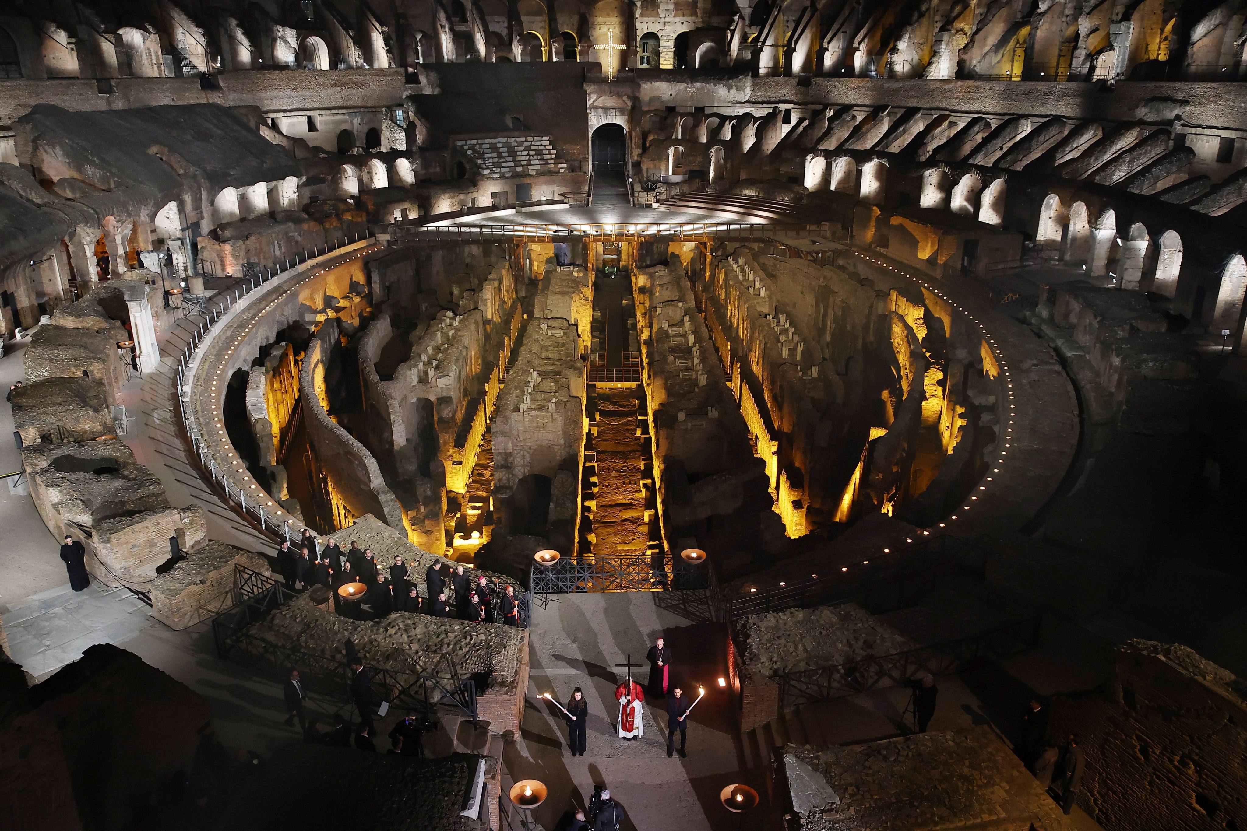 Pope Leo holds a wooden cross as he leads the Via Crucis procession at the Coliseum in Rome on Good Friday. Photo: dpa