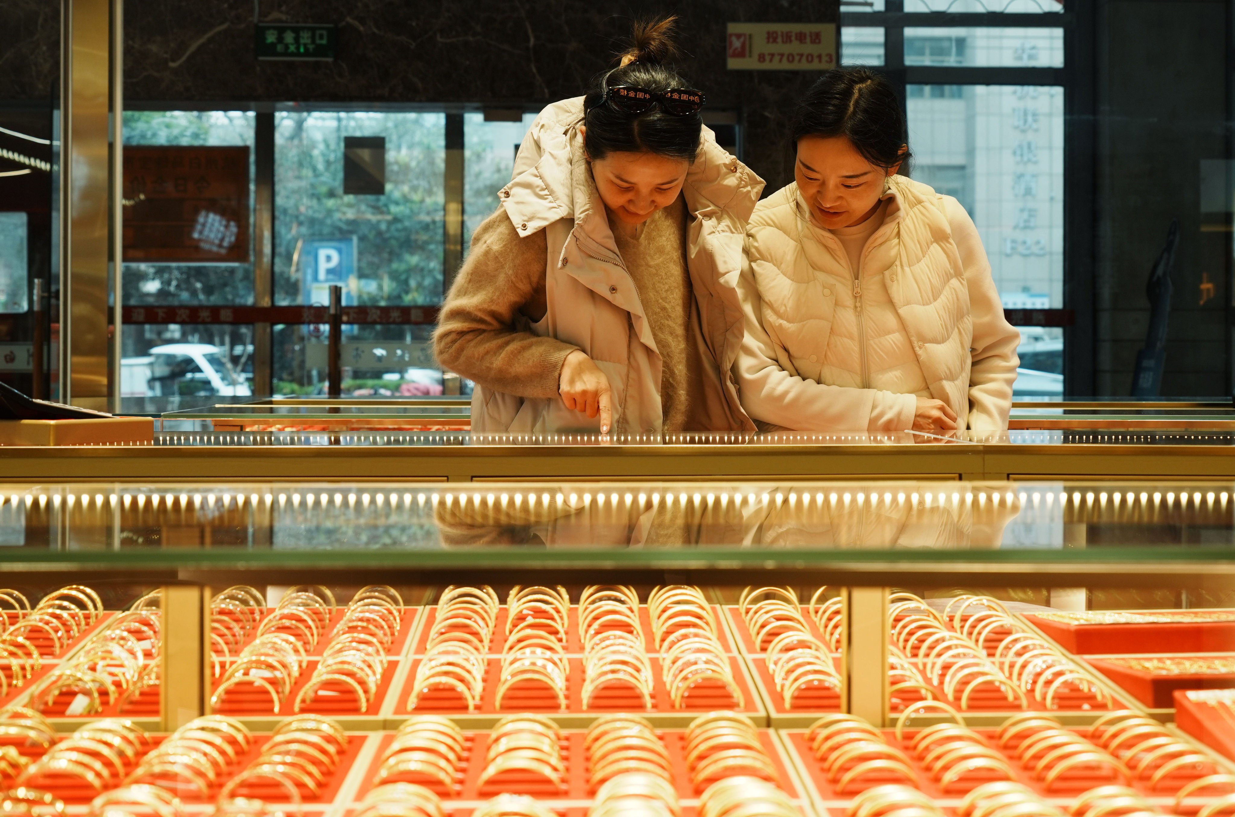 Customers look at gold jewelry at a store in Hangzhou, Zhejiang province, China on March 23, 2026. Photo: CFOTO/Future Publishing via Getty Images