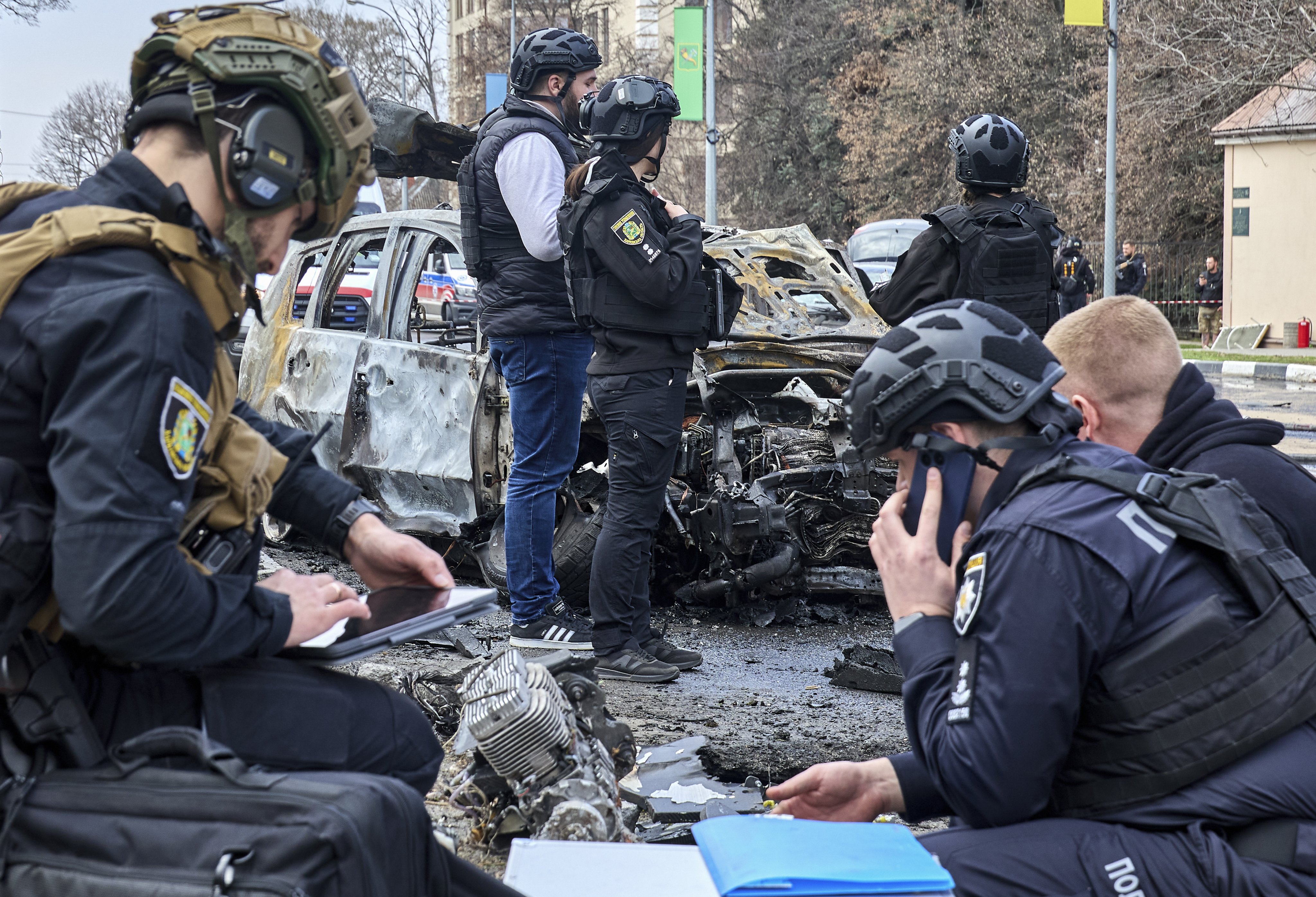 Ukrainian experts work at the site of a Russian drone strike on a residential area in Kharkiv, Ukraine, on Friday. Photo: EPA
