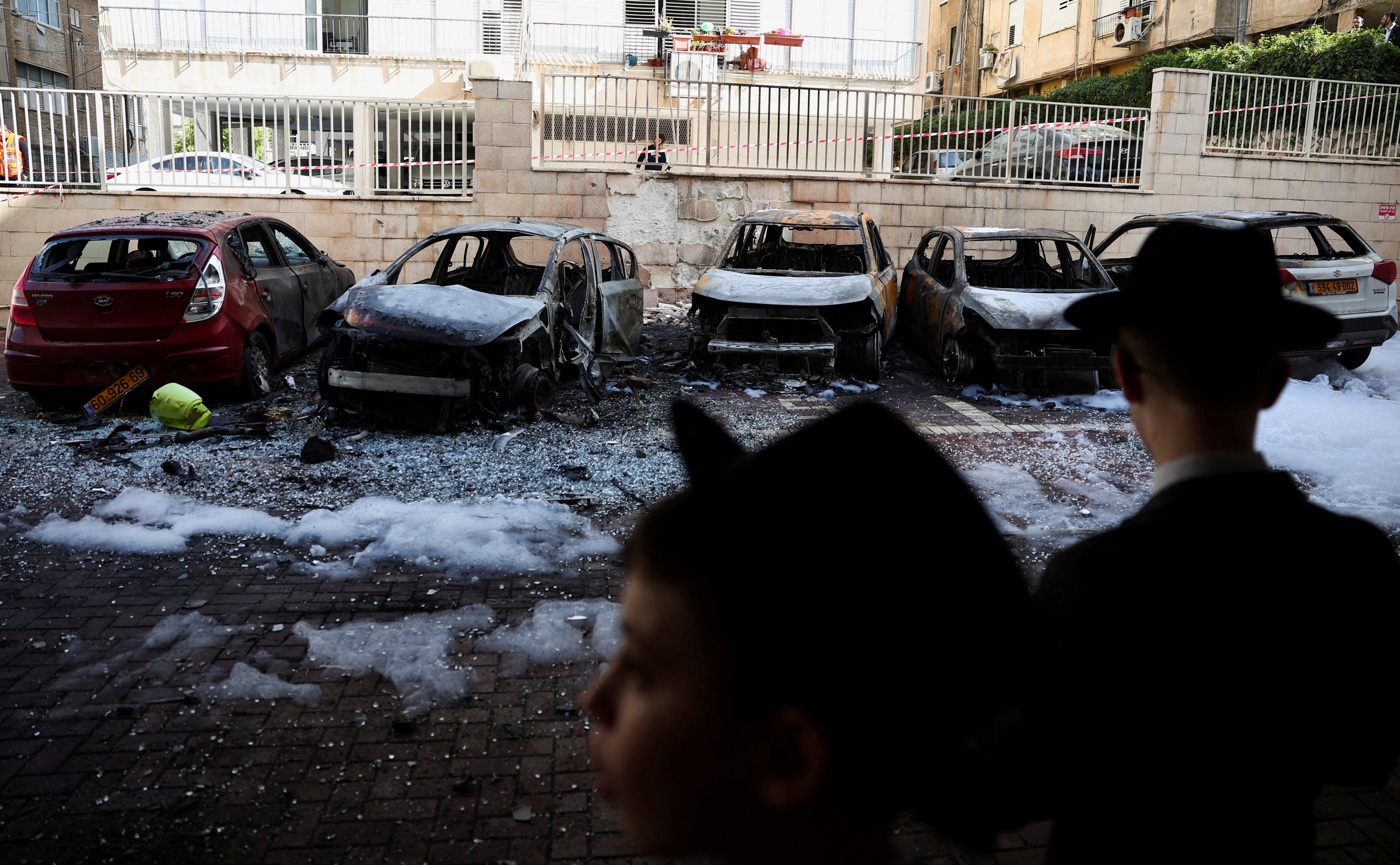 Burnt-out vehicles in Petah Tikva, Israel, following a barrage of missiles launched from Iran. Photo: Reuters