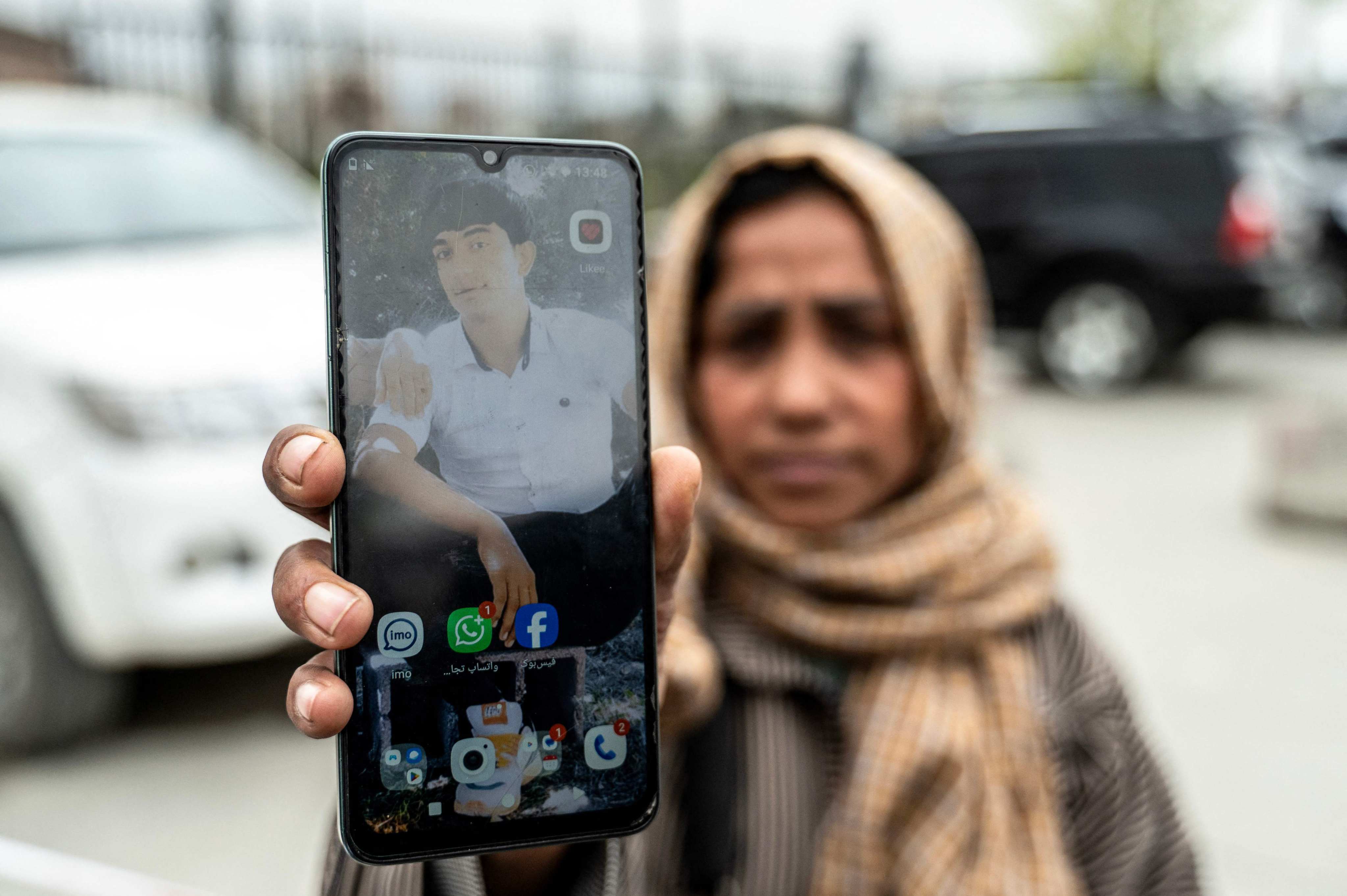 Samira Muhammadi holds up a photograph of her son, Aref Khan, who was killed by a Pakistani airstrike that struck a drug rehabilitation centre on March 16.Photo: AFP