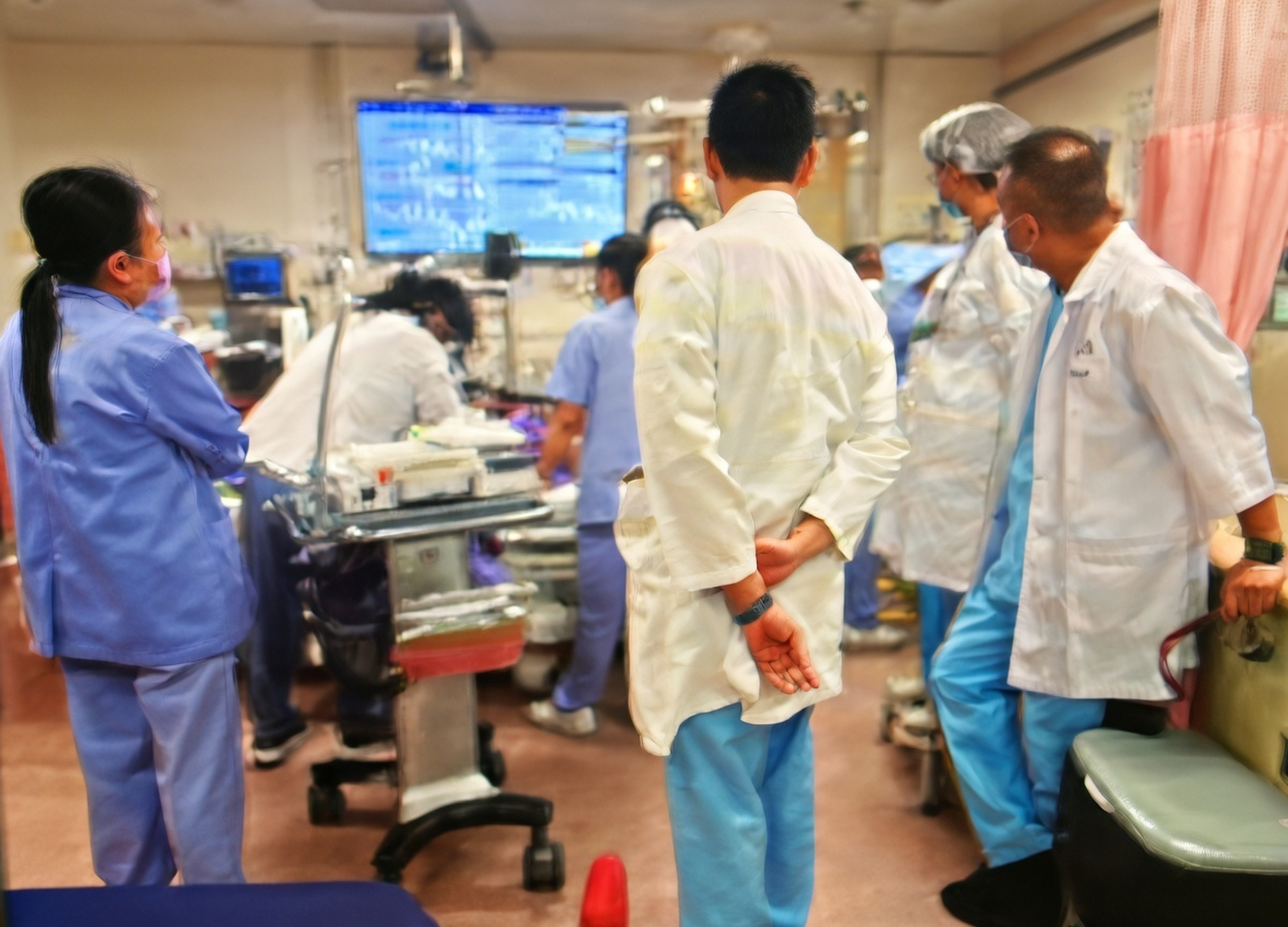 The photo shows Jensen So performing the procedure while surrounded by hospital staff. Photo: Handout