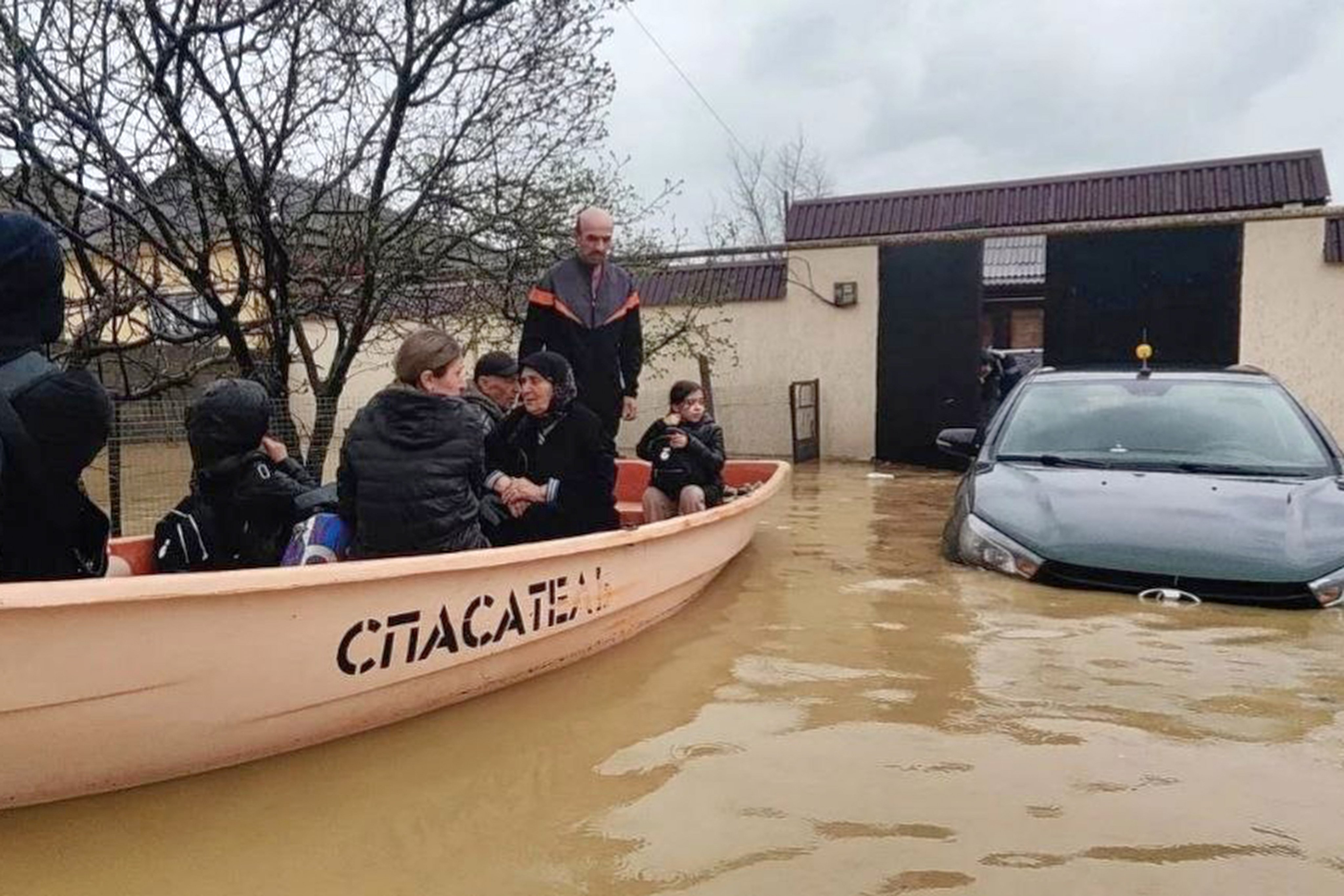 People are evacuated from a flood zone in Dagestan, Russia, on Sunday. Photo: Russian Emergency Ministry Press Service via AP