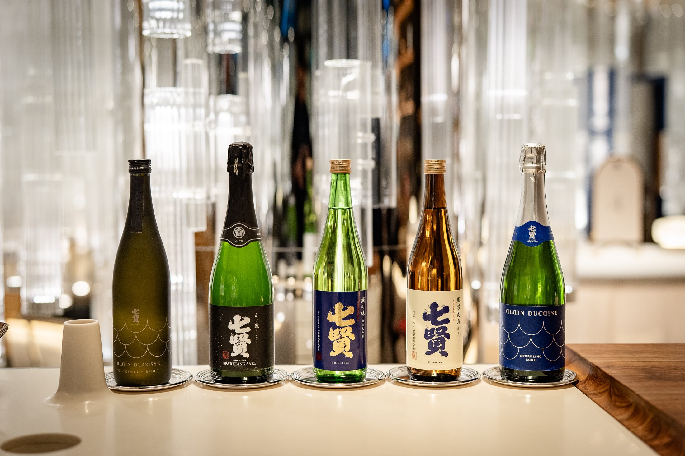 The wide selection of sakes available from Shichiken, a brewery in Daigahara, Hokuto city, in Japan’s Yamanashi prefecture, includes sparkling sake collaborations with French chef Alain Ducasse (pictured on the left and right). Photo: Shichiken