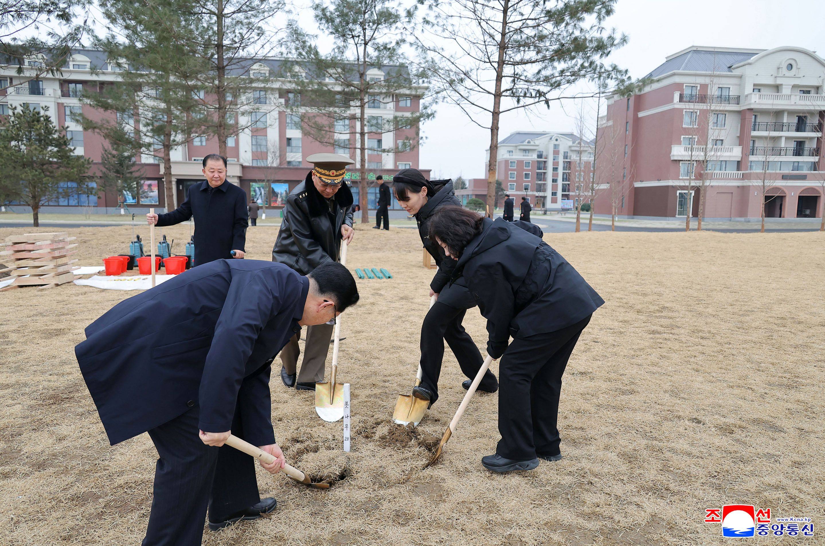 North Korean leader Kim Jong-un’s sister, Kim Yo-jong (second right) plants a tree in Pyongyang on March 14. Photo by KCNA/AFP