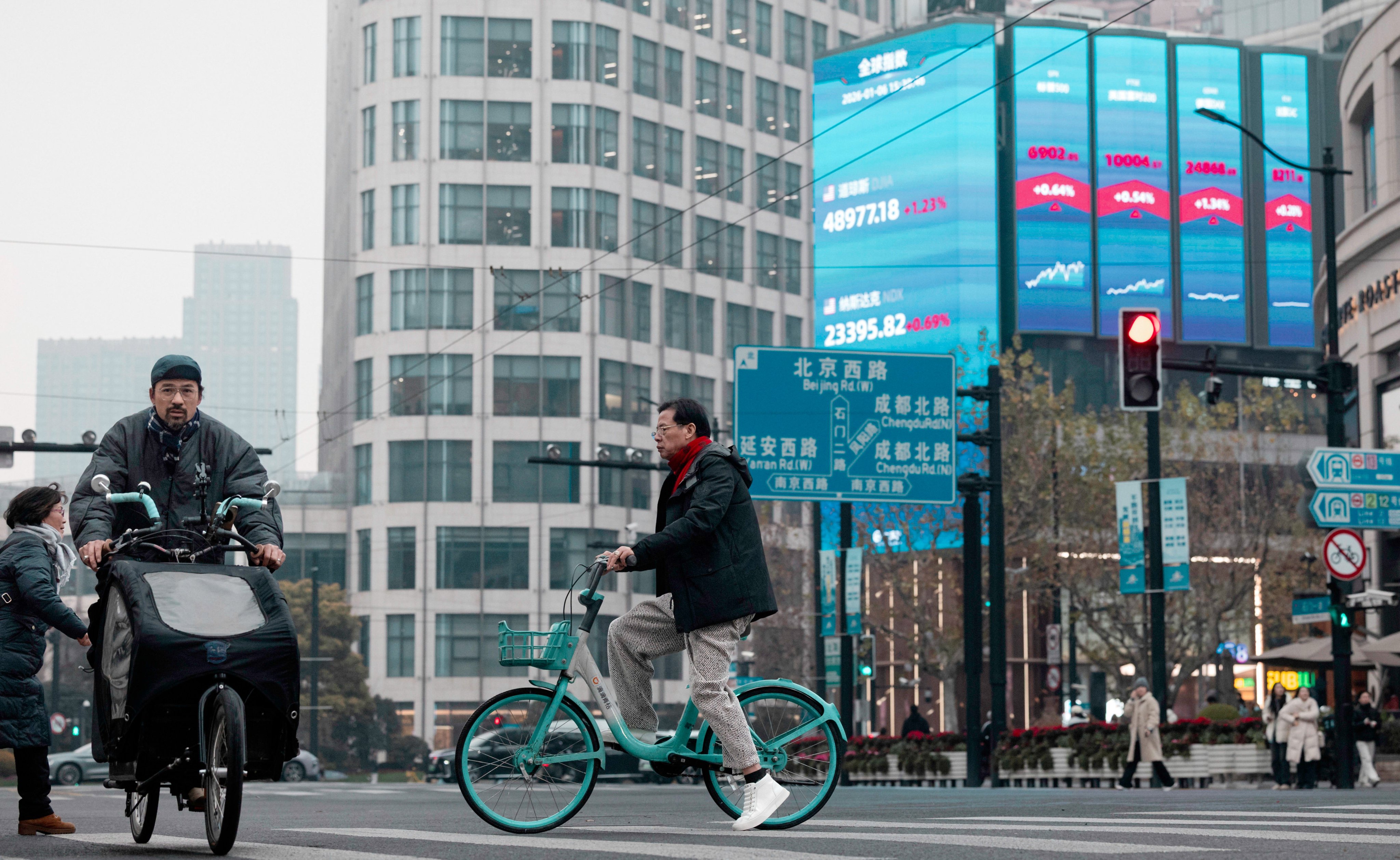 A huge screen displays the latest stock exchange and economic data in Shanghai. Photo: EPA