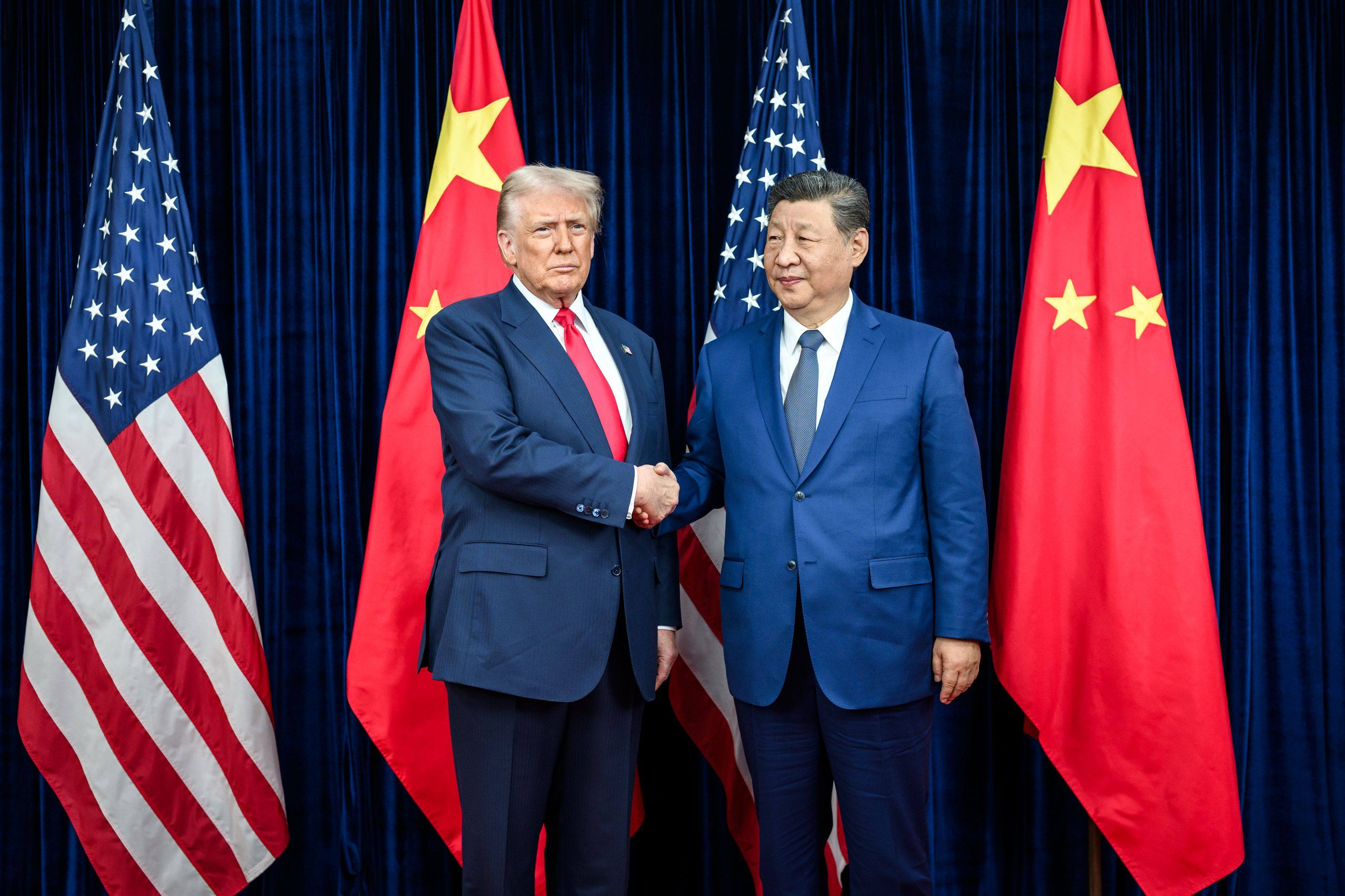 US President Donald Trump greets Chinese President Xi Jinping before a bilateral meeting at the Gimhae International Airport terminal in South Korea in October. Photo: Daniel Torok/White House/dpa