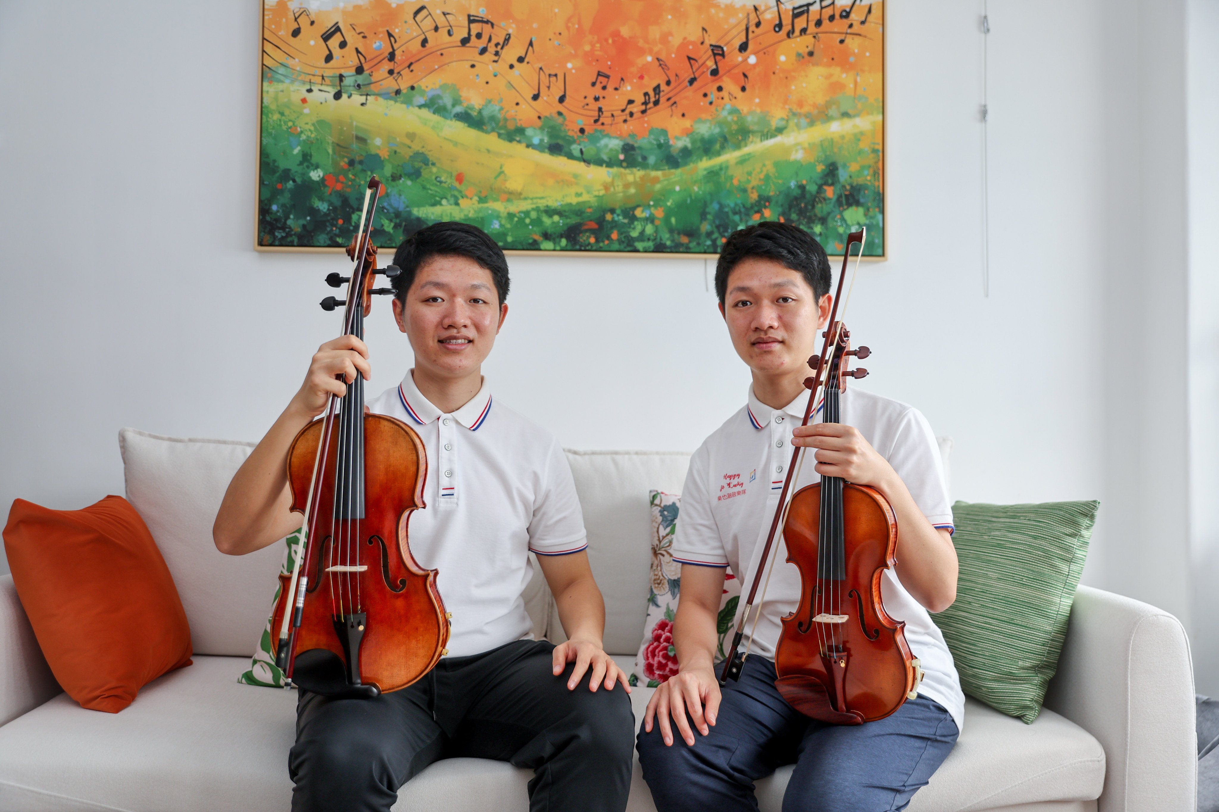 Twin violinists Hugo Pang (left) and Jayden Pang are pictured with their violins in Tsim Sha Tsui, Hong Kong. The twins, now in their mid-twenties, were diagnosed with autism as toddlers. Since then, music has helped stabilise their emotions and improve their communication. Photo: Edmond So
