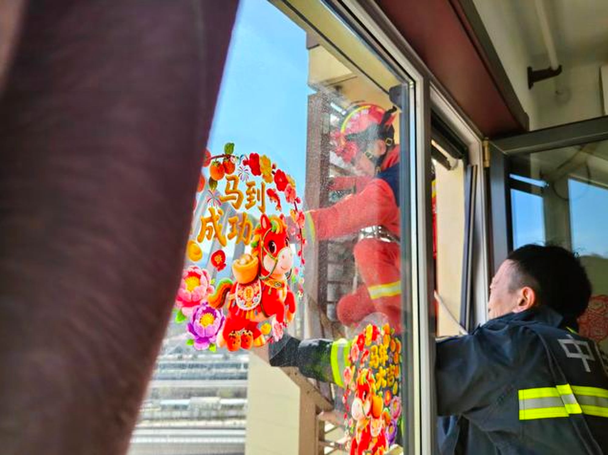 Firefighters, above, struggled and eventually moved the grandmother to safety. Photo: Sina
