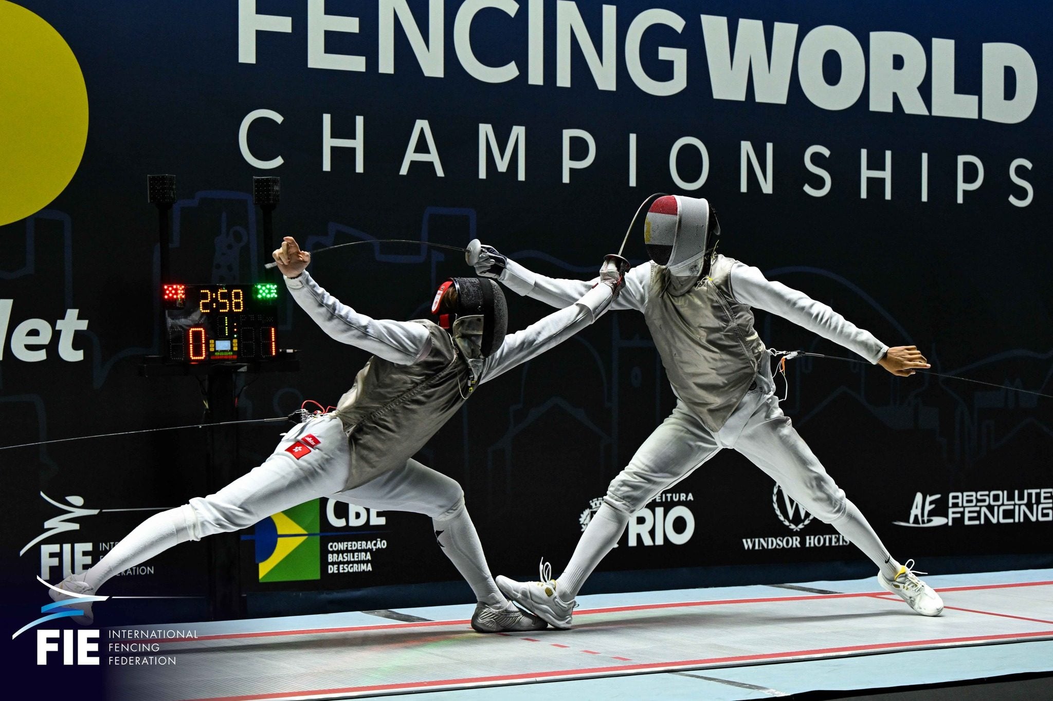 Hong Kong’s Lam Ho-long (left) beat Egypt’s Abdelrahman Tolba to win the men’s foil junior title on Sunday. Photo: International Fencing Federation (FIE)
