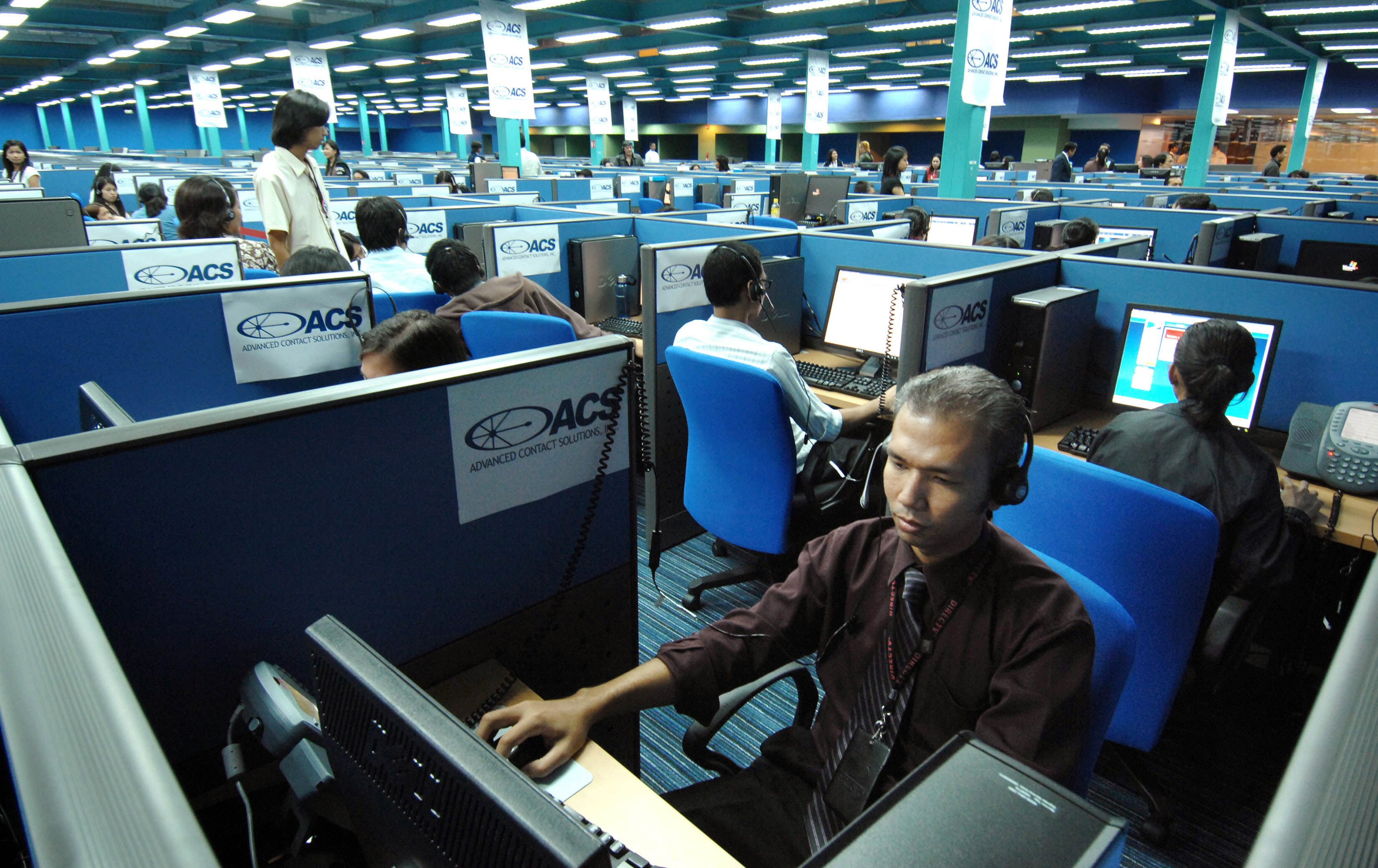 Filipino call centre personnel attend to their US clients at a business process outsourcing office in Manila. Photo: AFP