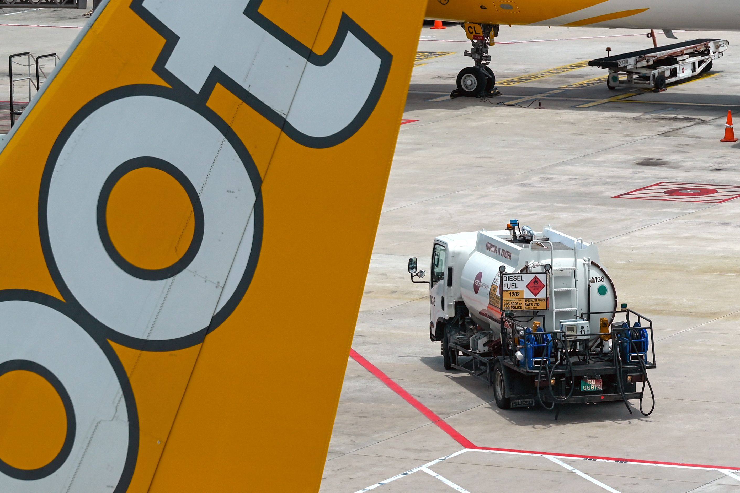 A truck carrying aviation fuel is pictured next to a Scoot plane at Singapore Changi Airport on March 13. Photo: AFP
