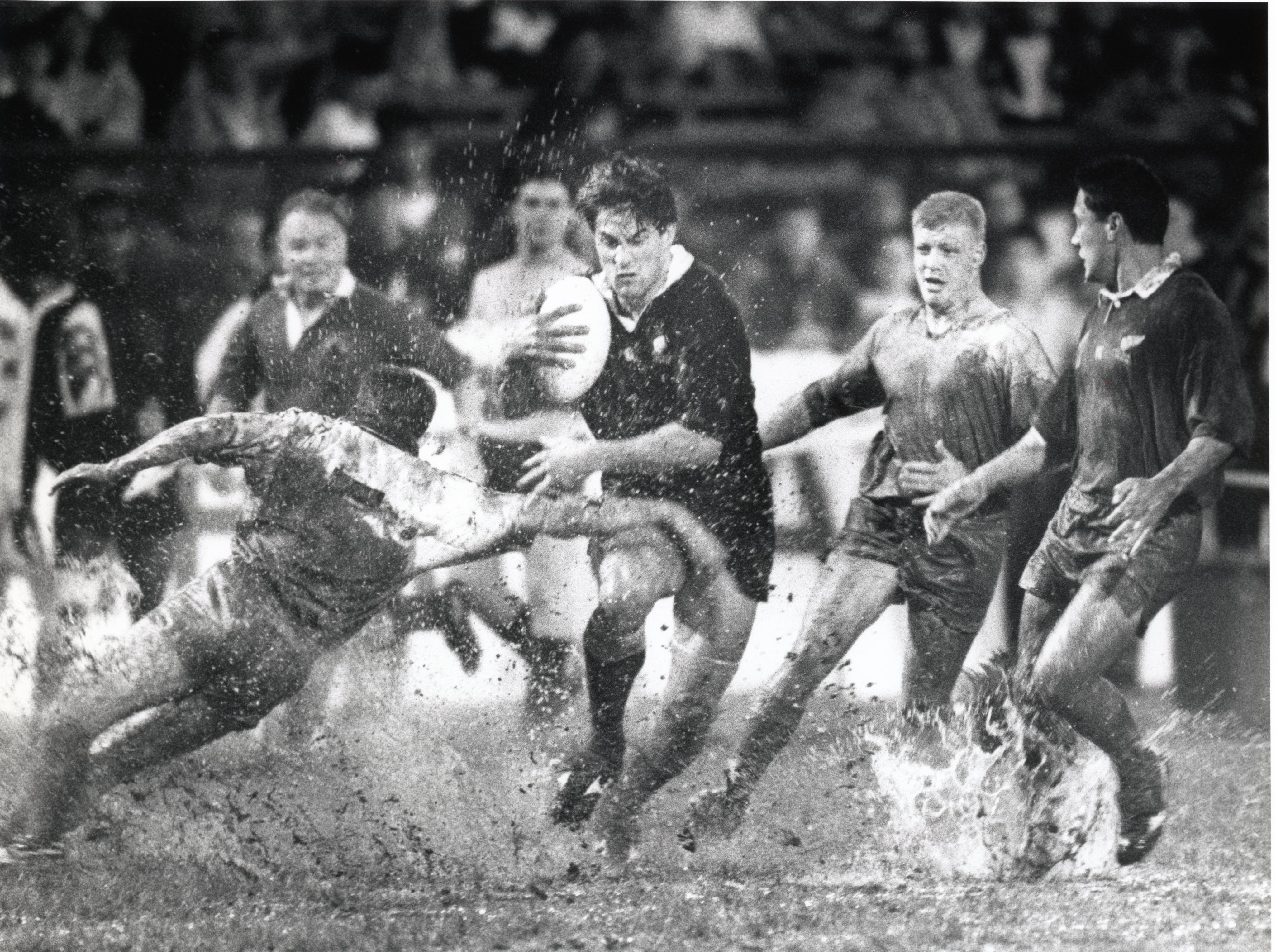 New Zealand’s Dallas Seymour powers his 
way through the mud 
as his team faces 
Hong Kong at the 
1992 Cathay Pacific-Hongkong Bank Invitation Sevens at Hong Kong Stadium. The All Blacks won, obviously. Photo: SCMP Archives