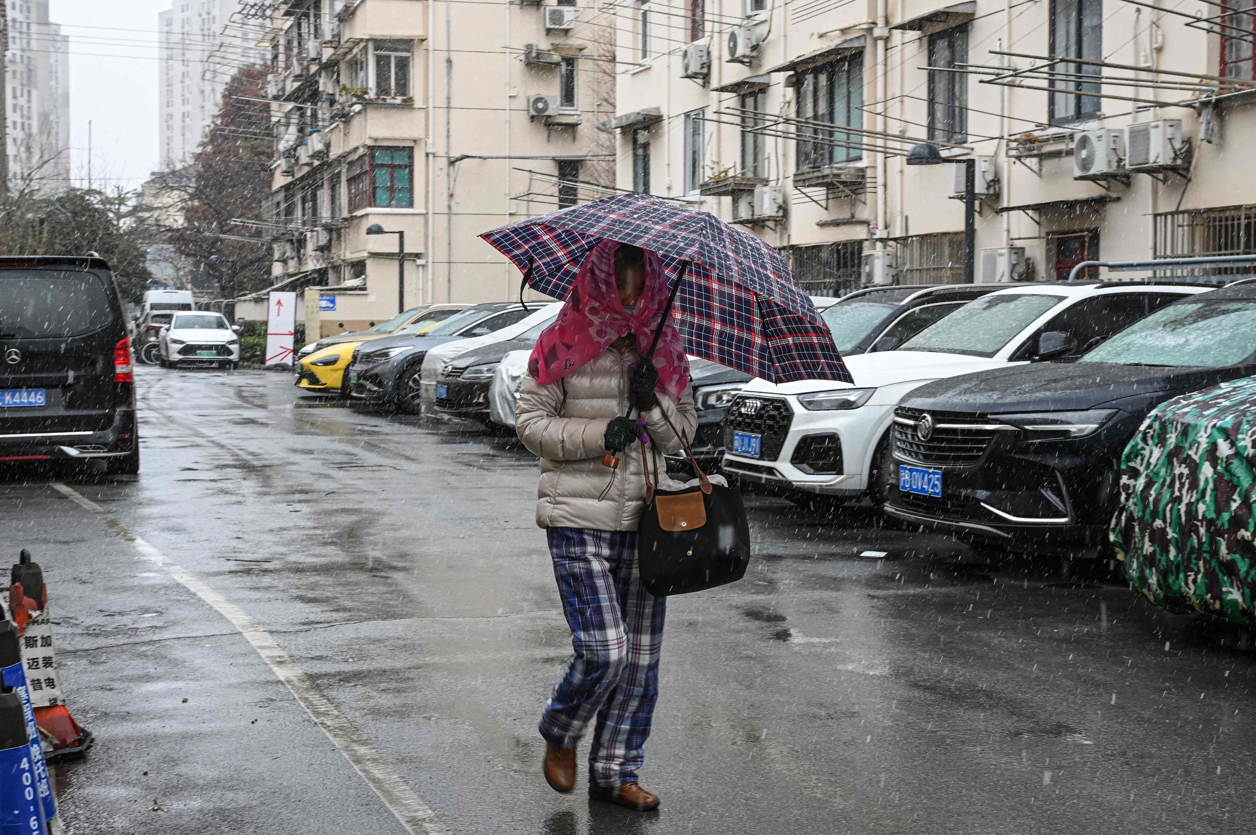 A woman walks through a residential compound in Shanghai on January 20. Photo: AFP
