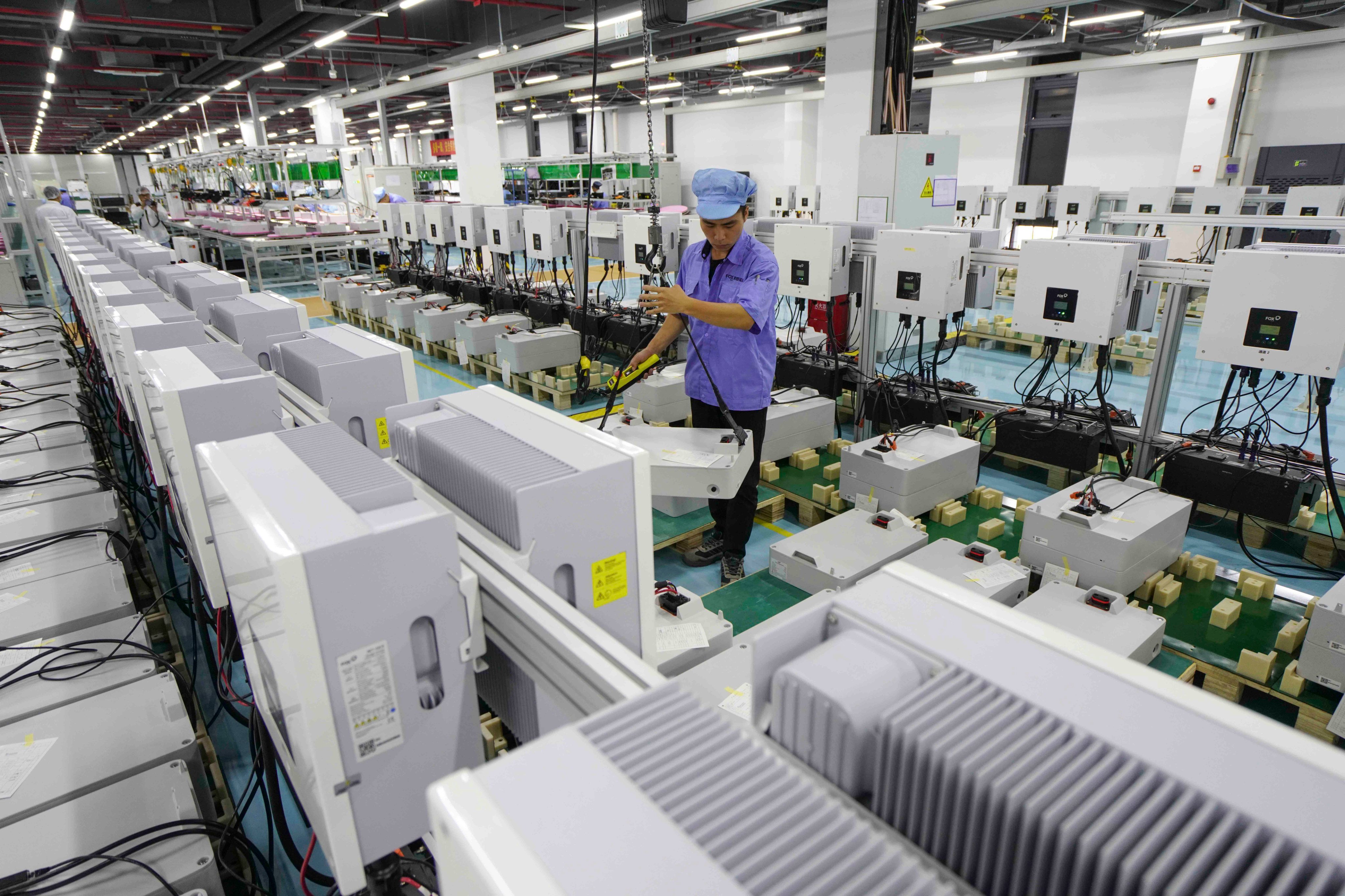 An employee works on the production line at FoxESS, a global leader in the development of inverter and energy storage solutions. Photo: Getty Images