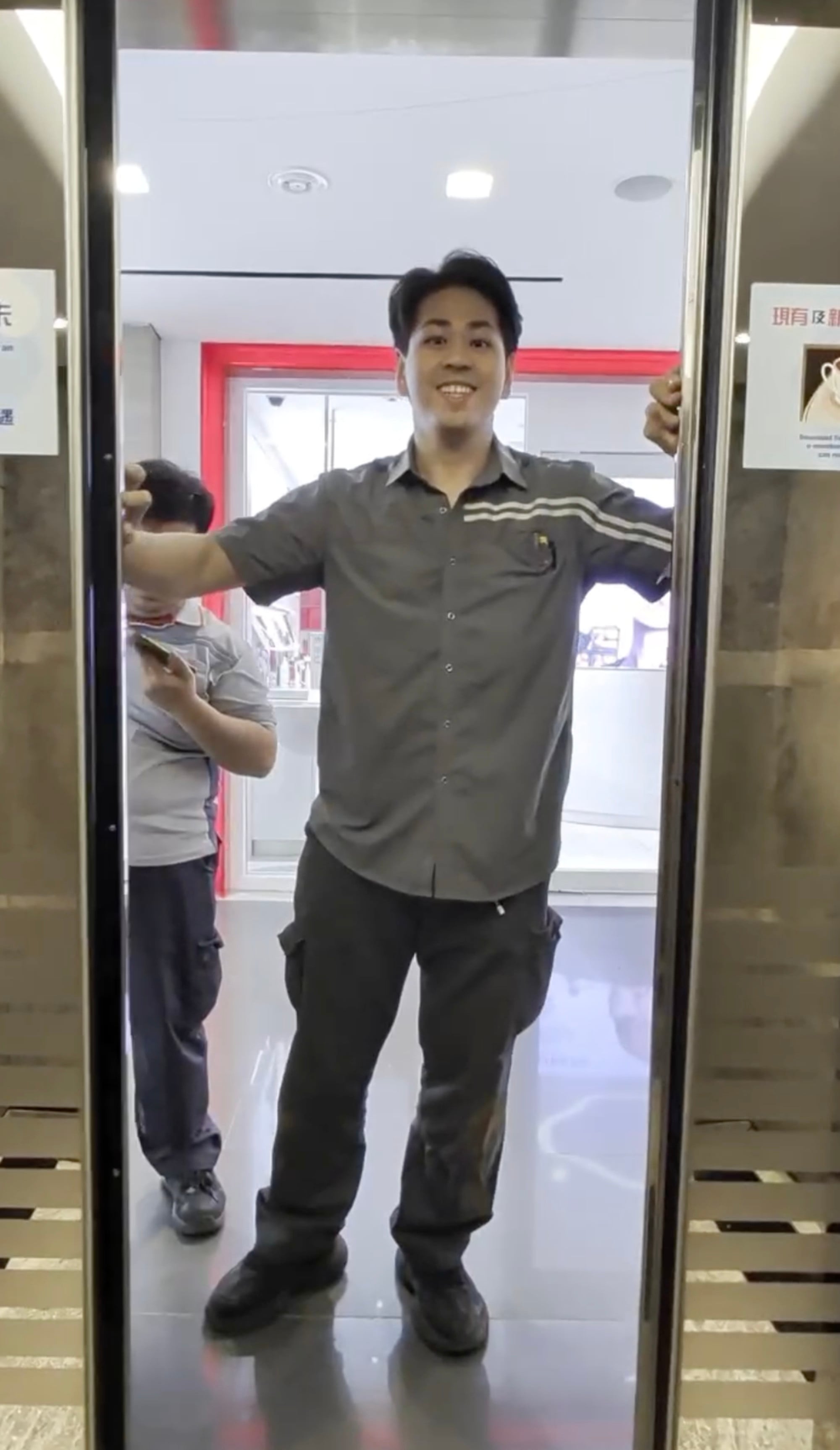 A worker opens the lift door for SCMP video director Chieu Luu. Photo: Chieu Luu