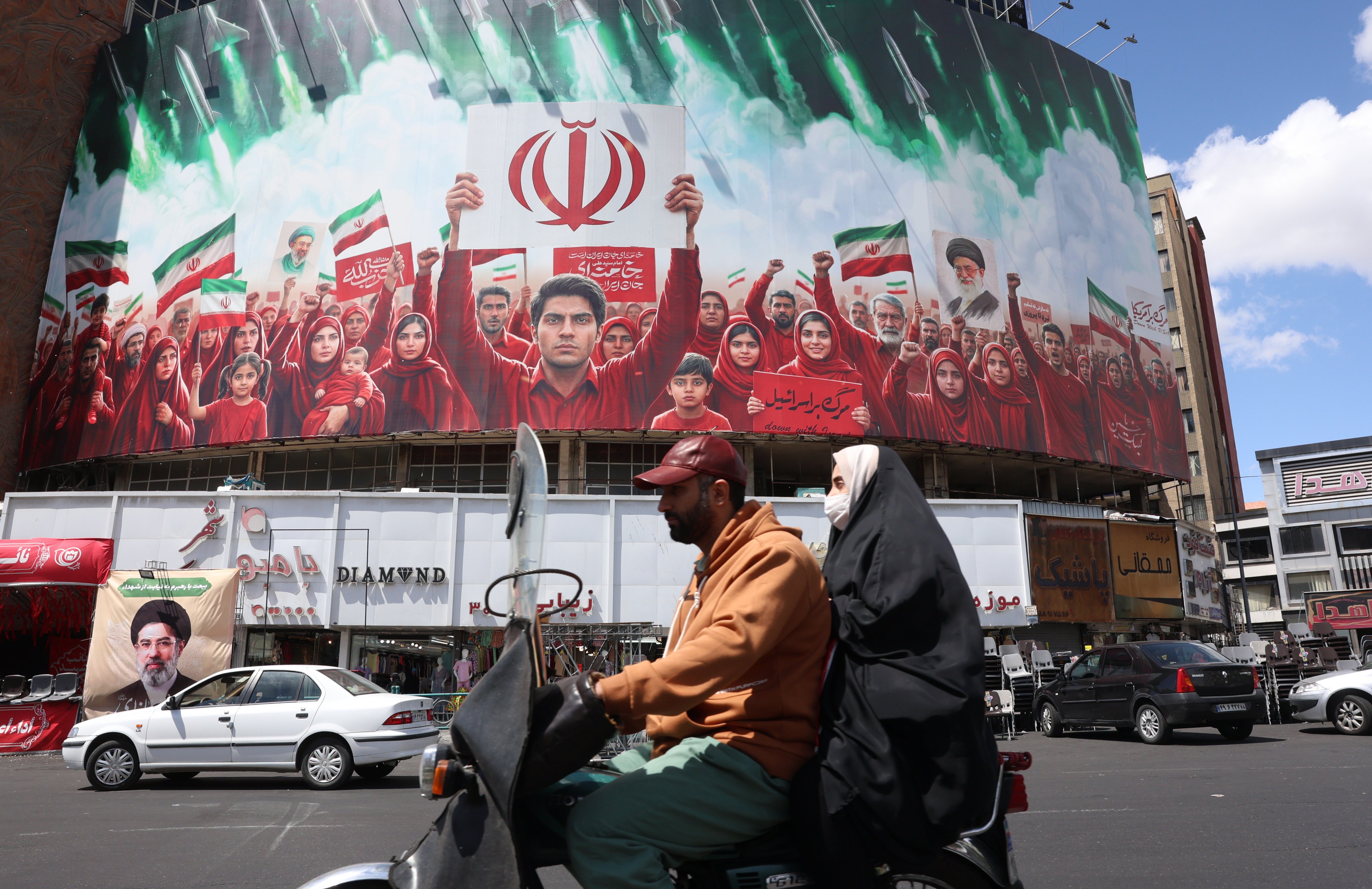 A political billboard in the colours of Iran’s national flag, seen at Tehran’s Valiasr Square on April 8. 
Formal US-Iran peace talks are set to begin in Islamabad, Pakistan, on April 10. Photo: EPA