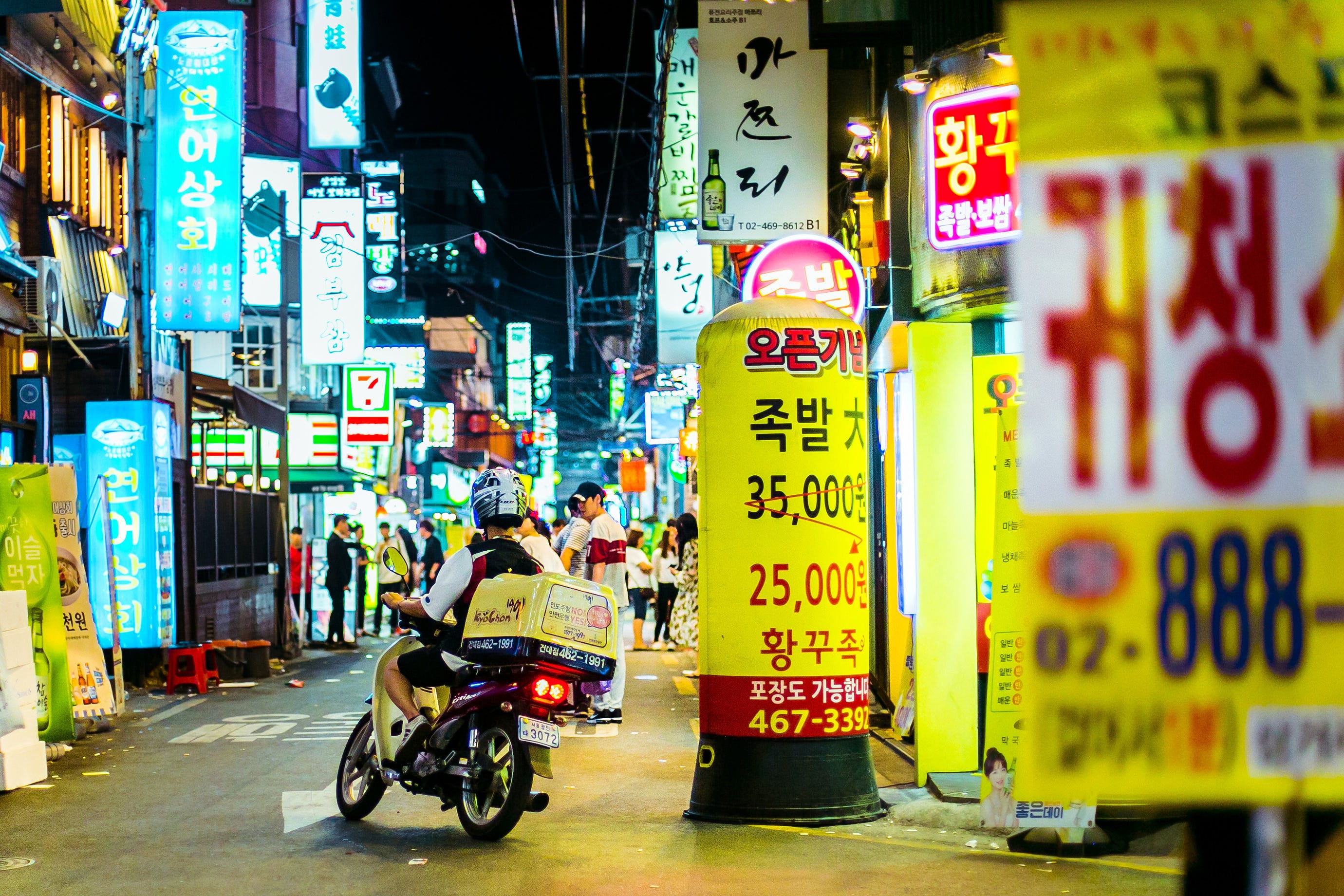 A delivery man makes his way on motorbike through Seoul’s busy Hongdae neighbourhood. Photo: Shutterstock
