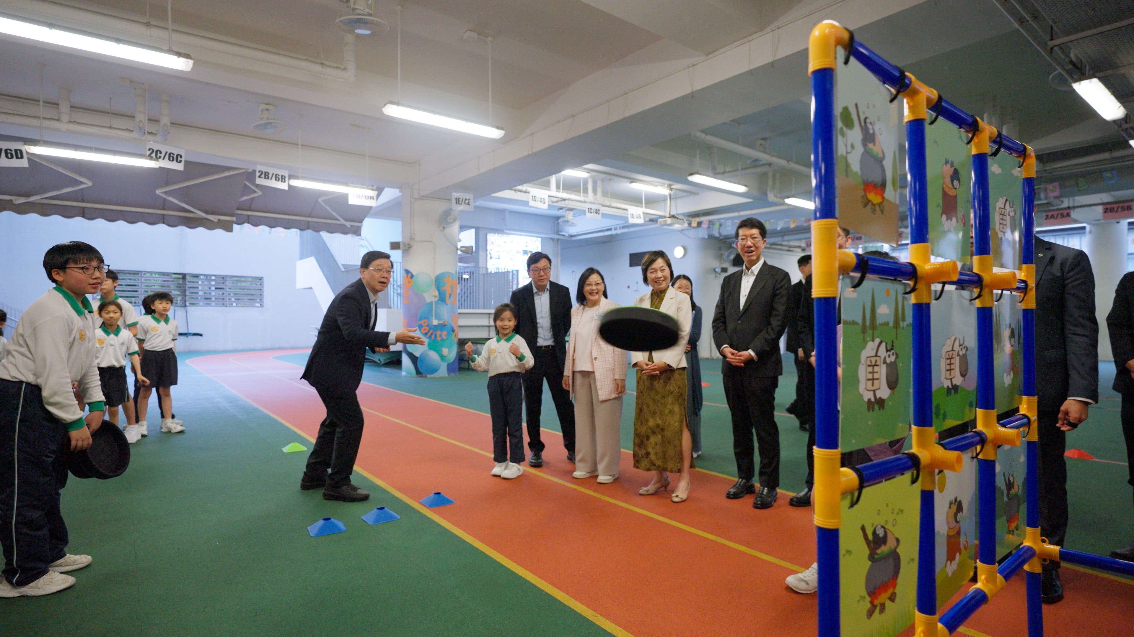 Chief Executive John Lee visits a school on March 27. He has pledged to expand the School-based After-School Care Service Scheme. Photo: Handout