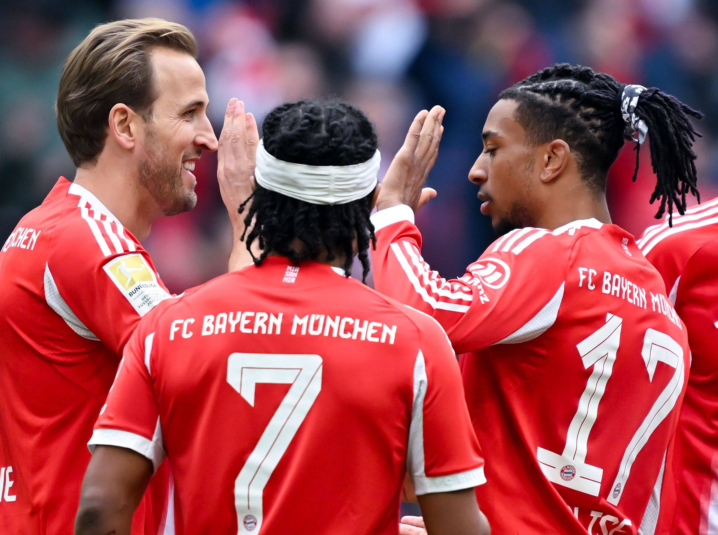 England captain Harry Kane (left) celebrates a goal with Bayern Munich teammates Serge Gnabry (centre) and Michael Olise. Photo: dpa
