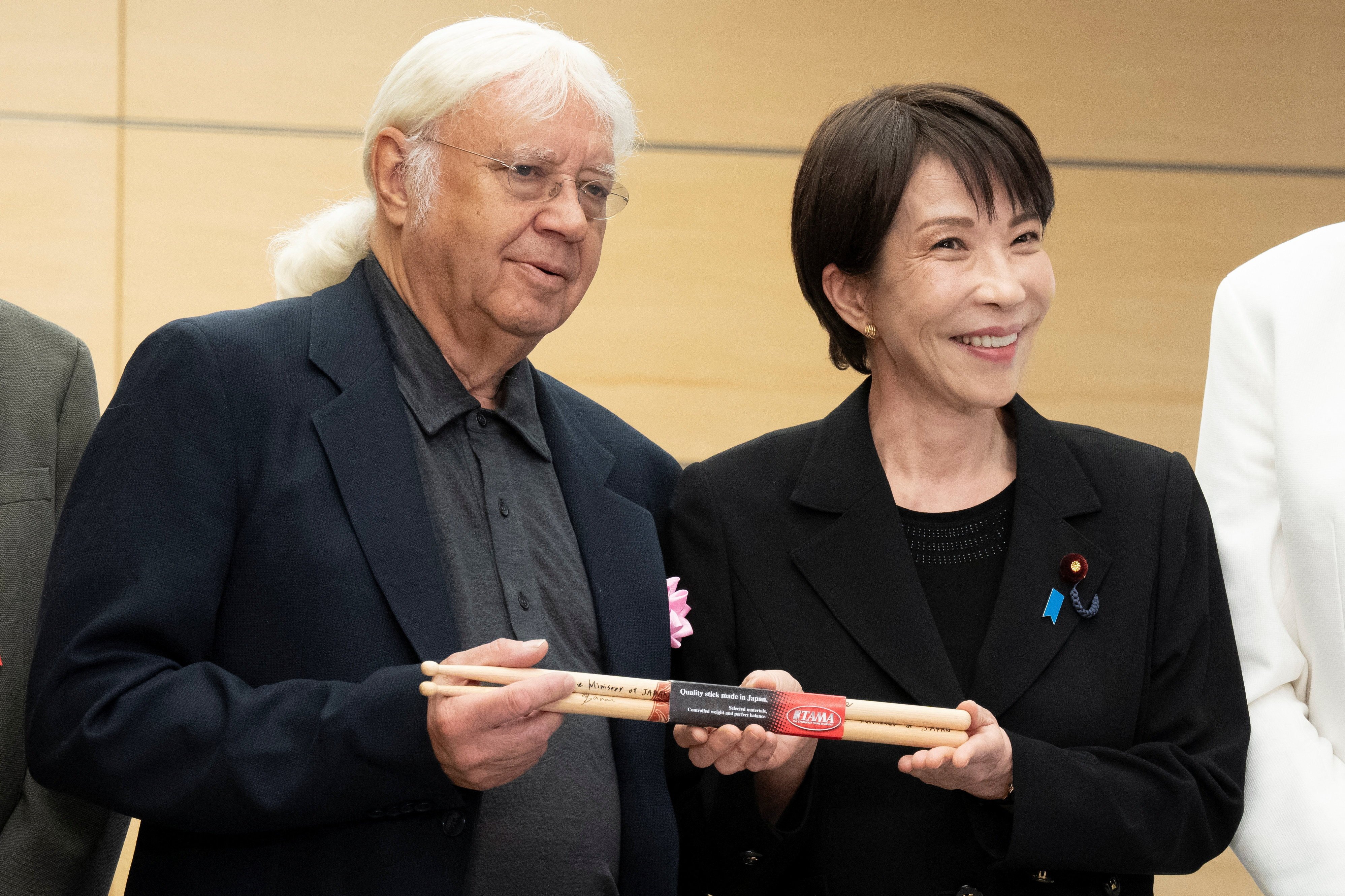 Japanese Prime Minister Sanae Takaichi gives Made-in-Japan drumsticks to Deep Purple drummer Ian Paice  at the Prime Minister’s Office in Tokyo on Friday. Photo: Reuters