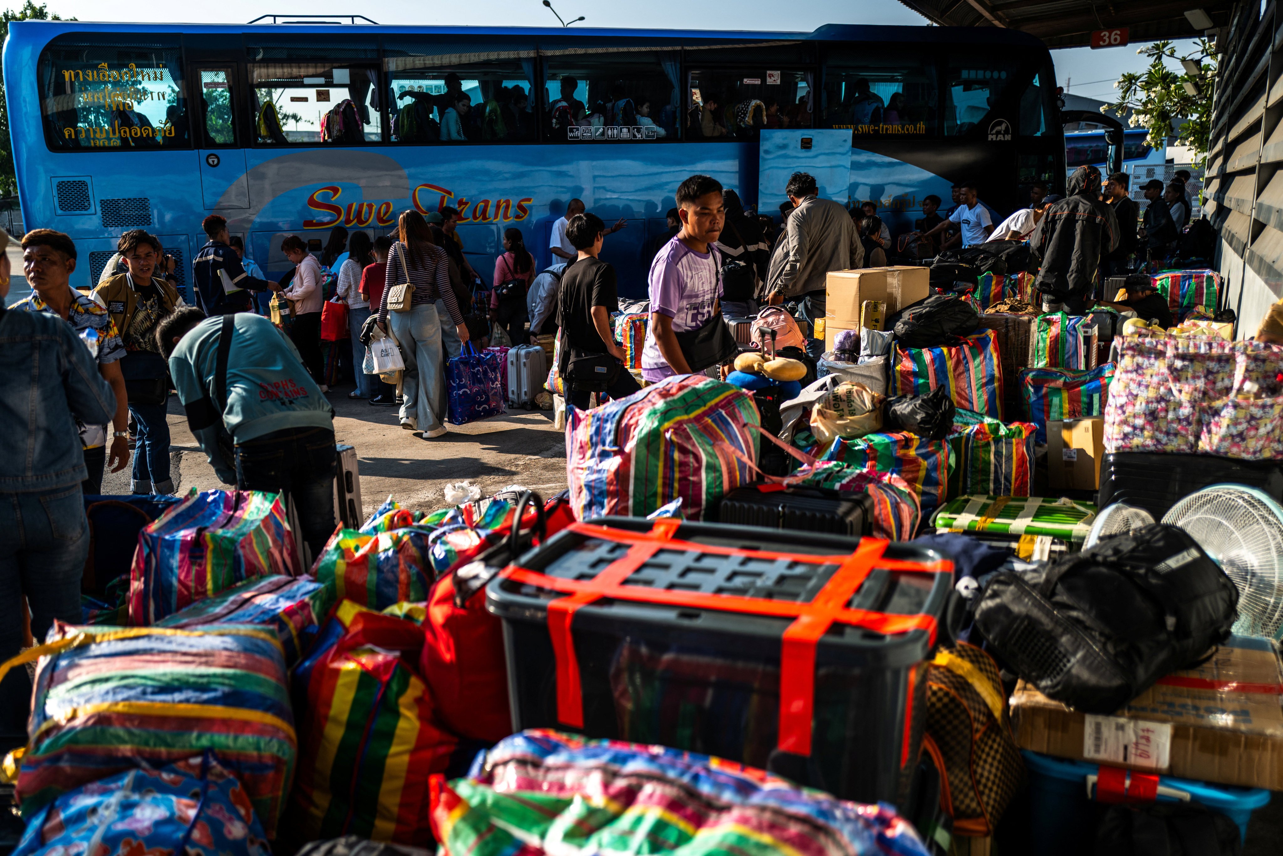 Passengers wait at Mo Chit bus terminal with their belongings to travel back home during the Thai traditional New Year Songkran holiday, in Bangkok, Thailand, on Friday. Photo: Reuters