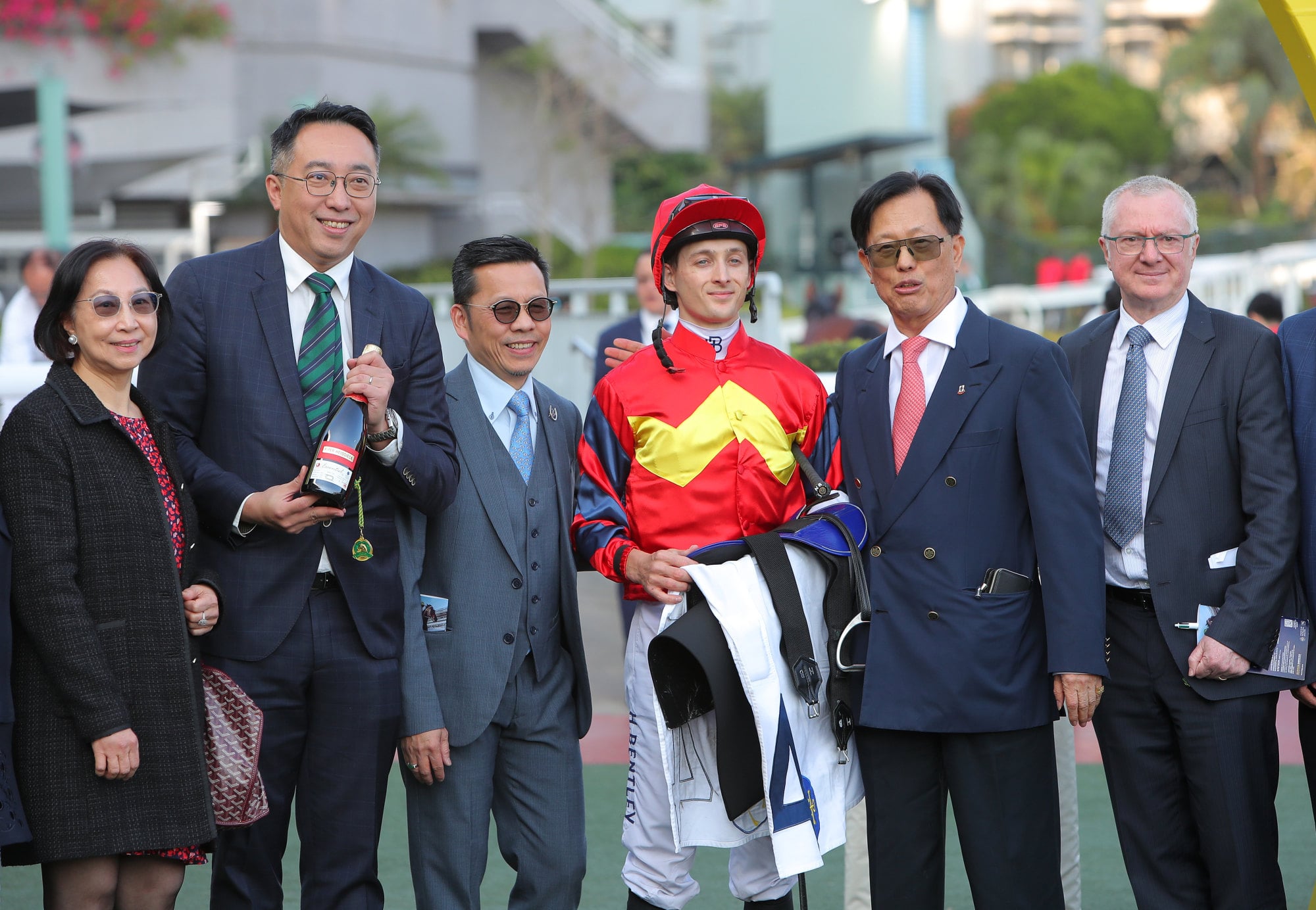 Frankie Lor (third from left) and jockey Harry Bentley celebrate the win of Smart Golf with connections at Sha Tin. Frankie Lor (third from left) and jockey Harry Bentley celebrate the win of Smart Golf with connections at Sha Tin.