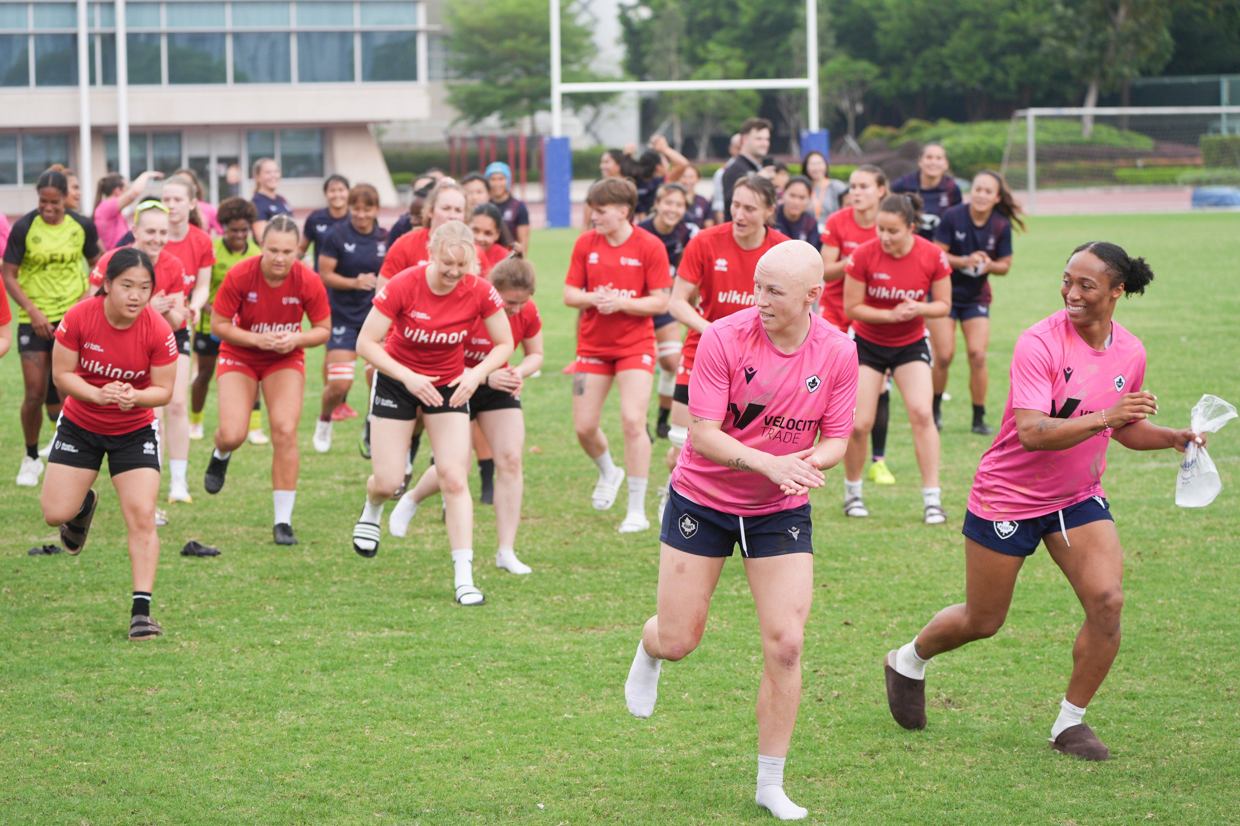 Canada’s Olivia Apps (left) and Charity Williams (right) lead a post-training dance session at Hong Kong Sports Institute with their teammates and players from Hong Kong and Fiji. Photo: Eugene Lee