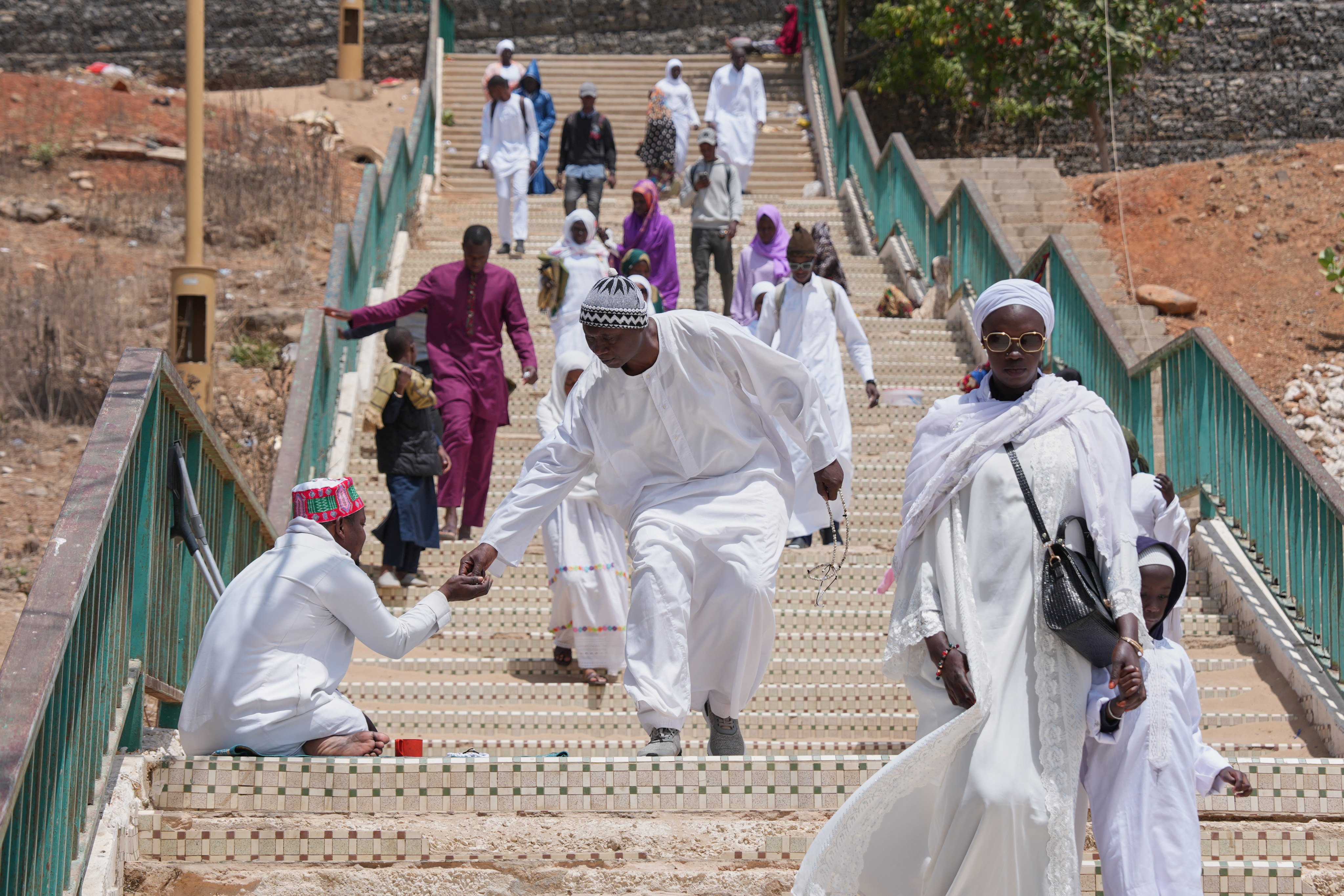 A man gives alms to a beggar in Dakar, Senegal, last month during the last Friday of the holy month of Ramadan. Photo: AP