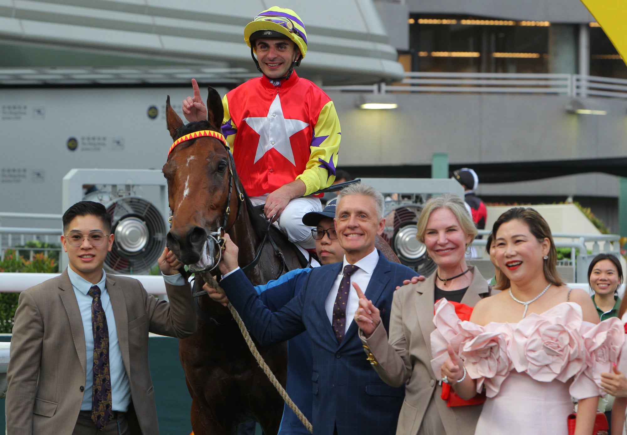 Andrea Atzeni and Mark Newnham celebrate the win of Crimson Flash alongside connections. Andrea Atzeni and Mark Newnham celebrate the win of Crimson Flash alongside connections.
