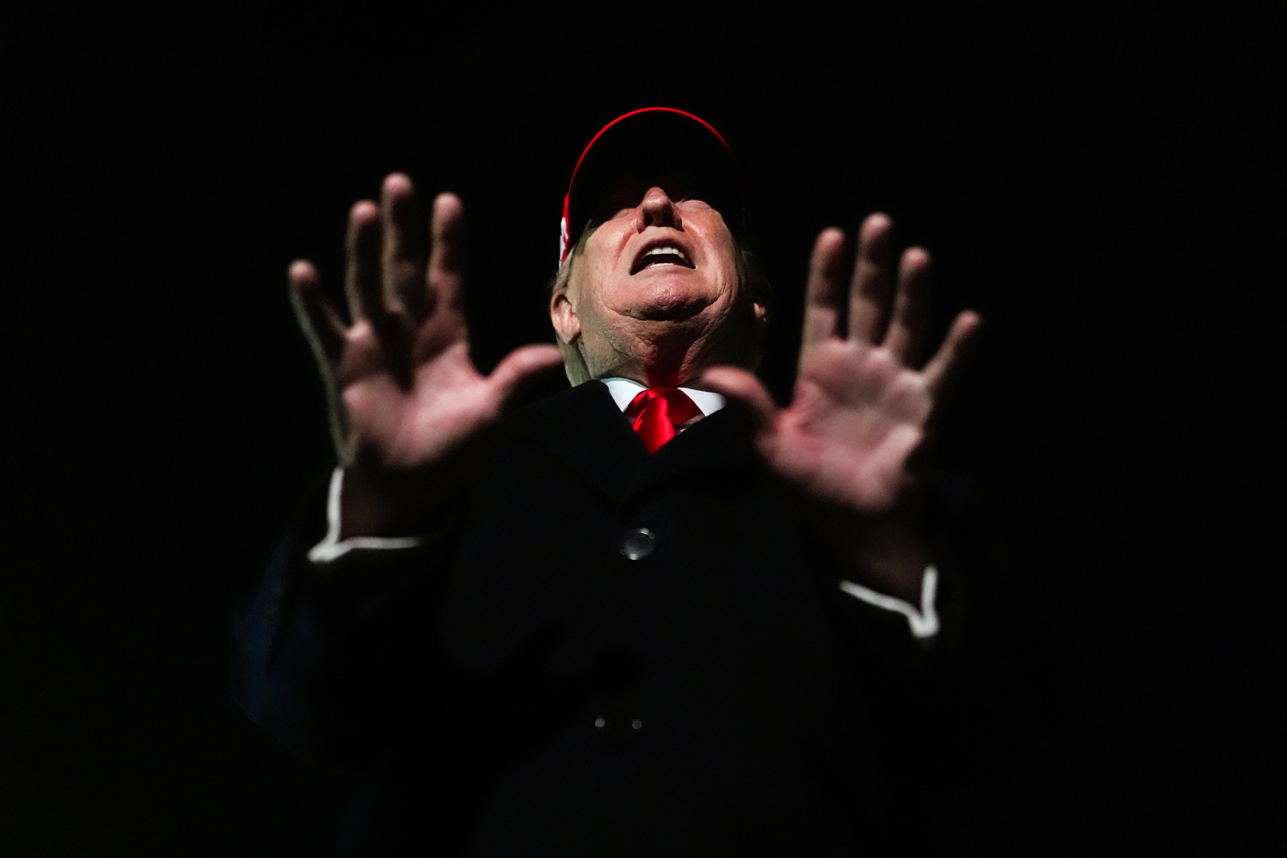 President Donald Trump speaks with reporters after disembarking Air Force One on Sunday, April 12. Photo: AP