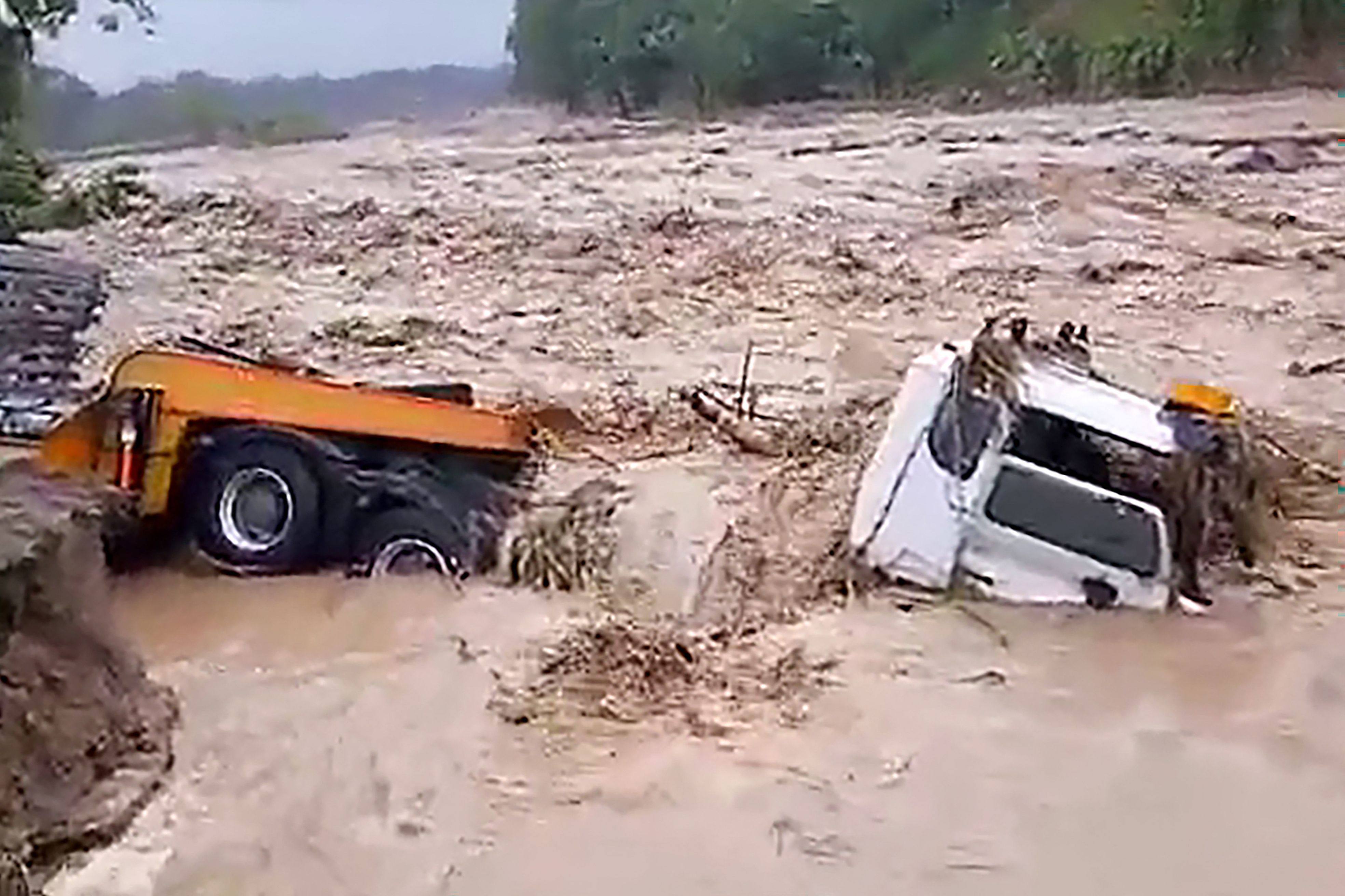 A truck is engulfed by floodwaters brought on by heavy rains from tropical cyclone Maila in the Tinputz district of Northern Bougainville. Photo: AFP