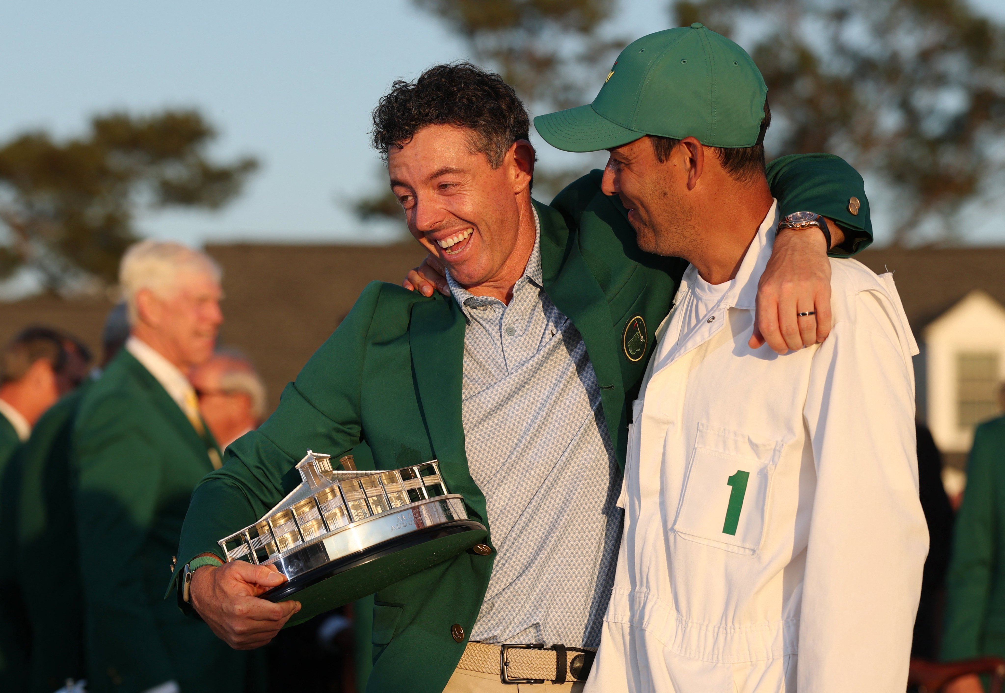 Rory McIlroy (left) with his caddie Harry Diamond as he celebrates winning his second green jacket. Photo: Reuters