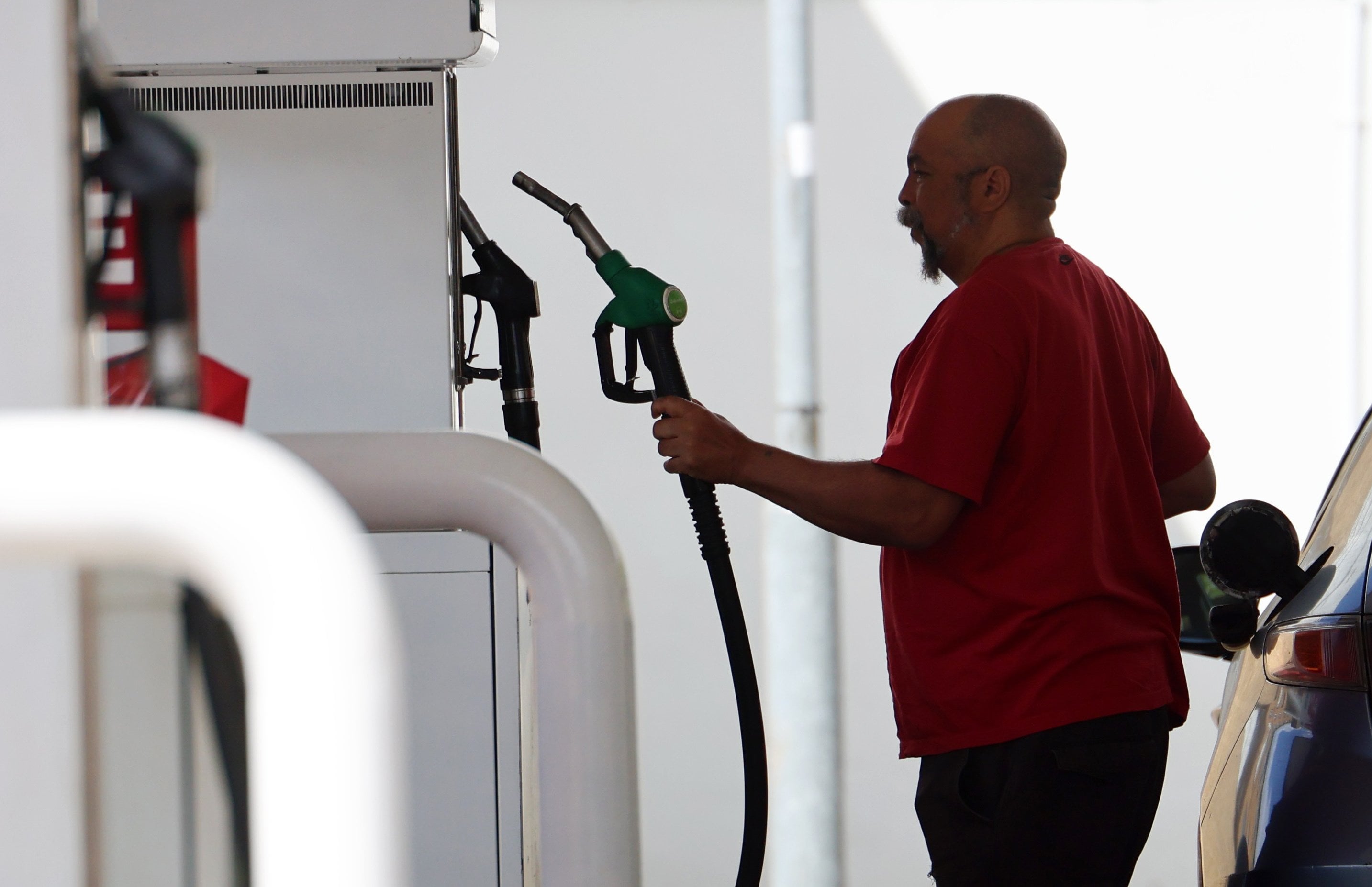 A customer at a petrol station in London on Monday. Photo: EPA