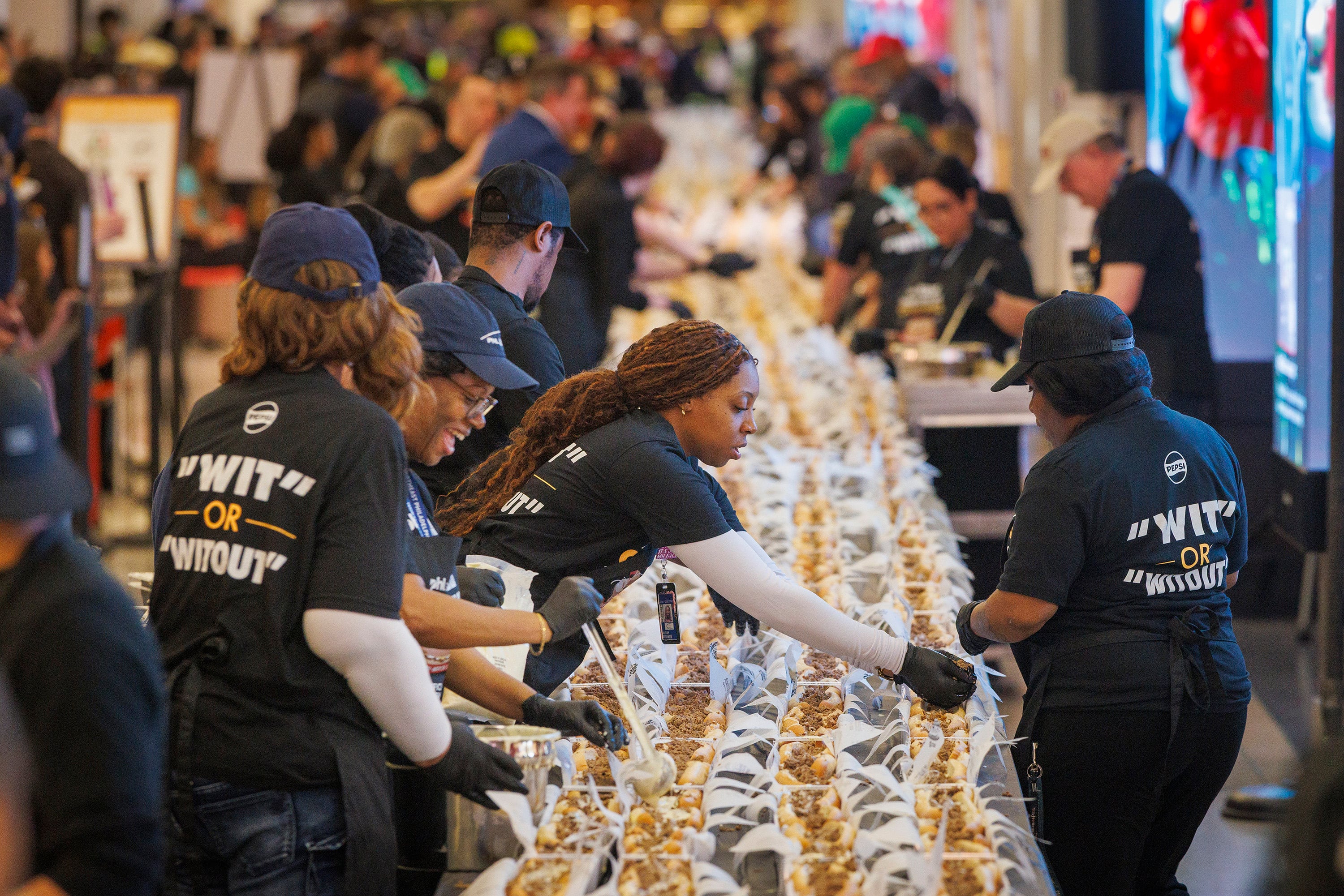 Cheesesteaks are assembled at Philadelphia International Airport Tuesday in an attempt to set a Guinness World Record for the longest line of cheesesteaks. Photo: TNS