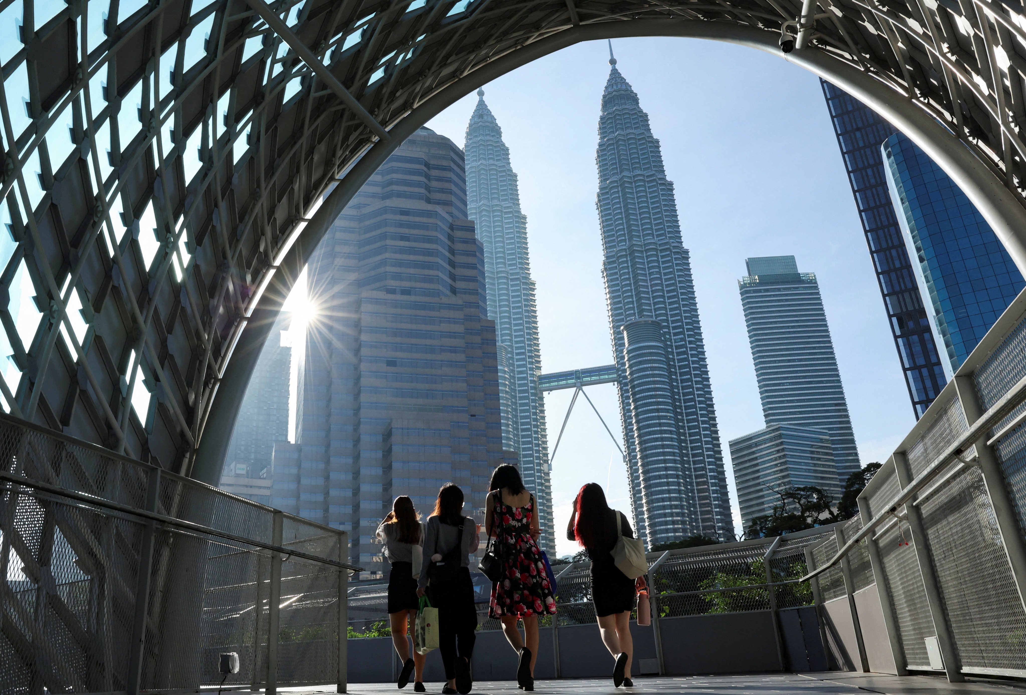 People walk to their workplace during the morning rush at Kuala Lumpur city centre, Malaysia. Photo: Reuters