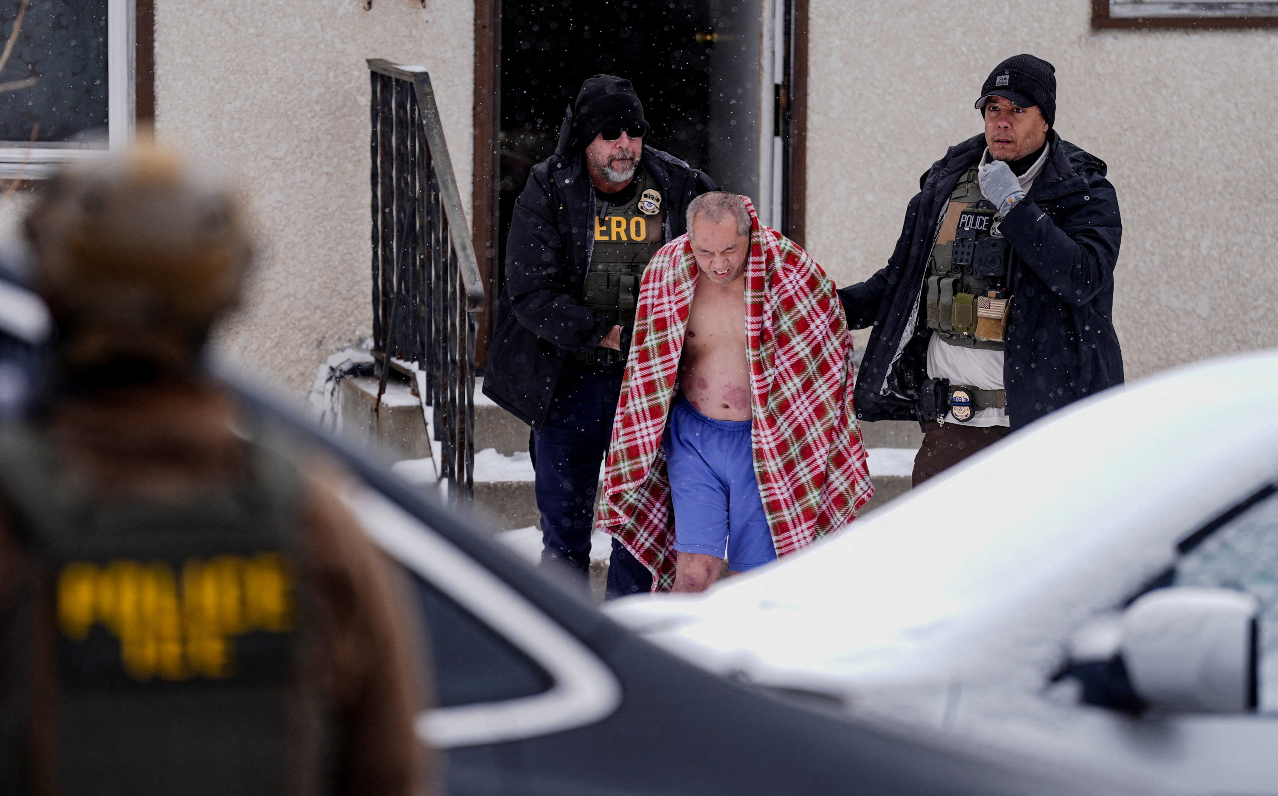 Immigration agents remove ChongLy ‘Scott’ Thao from his home on January 18. Photo: Reuters