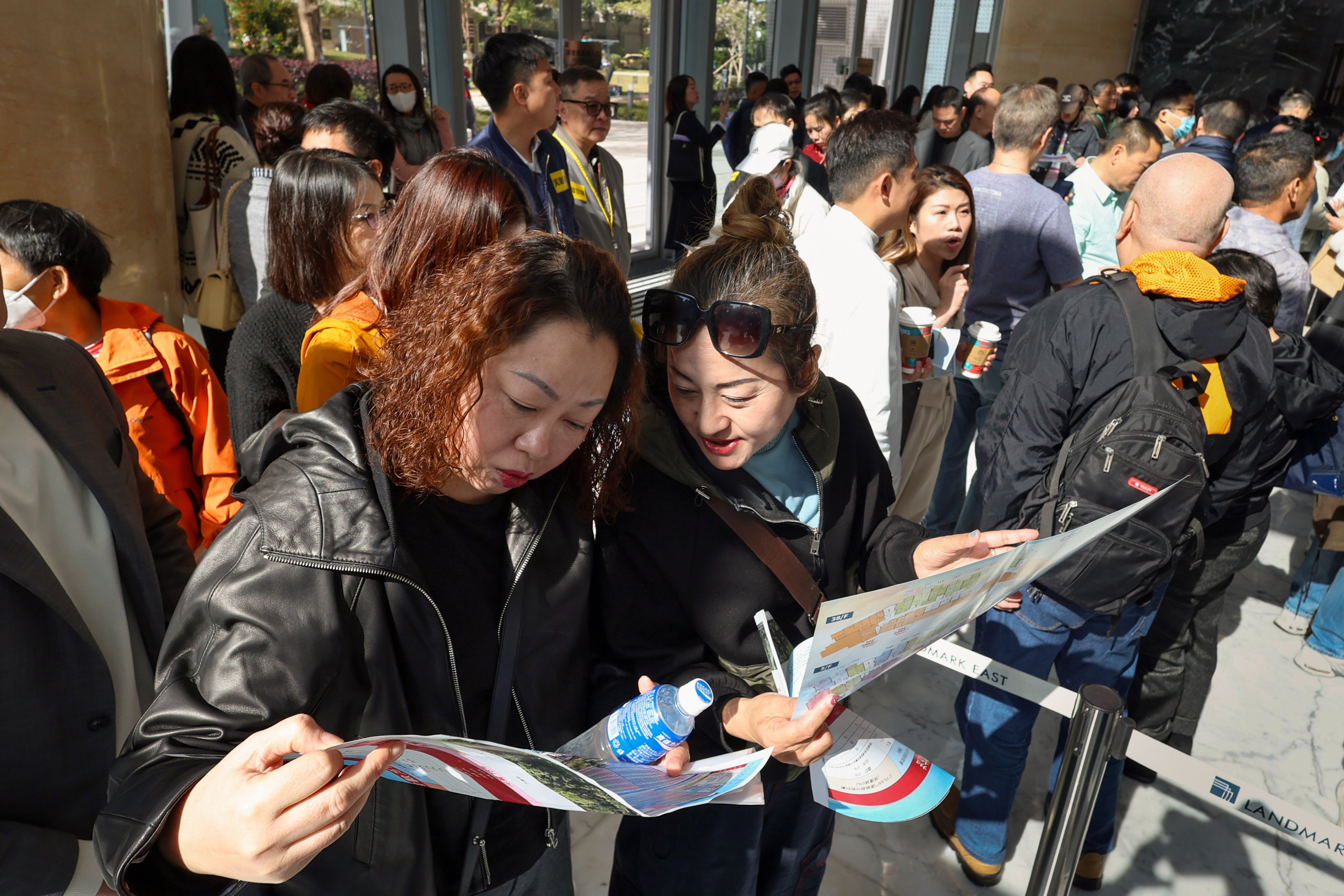 Prospective buyers pore over brochures on the first day of the sale of Cloudview, the new development in Sheung Shui by Wing Tai Properties, on March 14, 2026. Photo: Dickson Lee