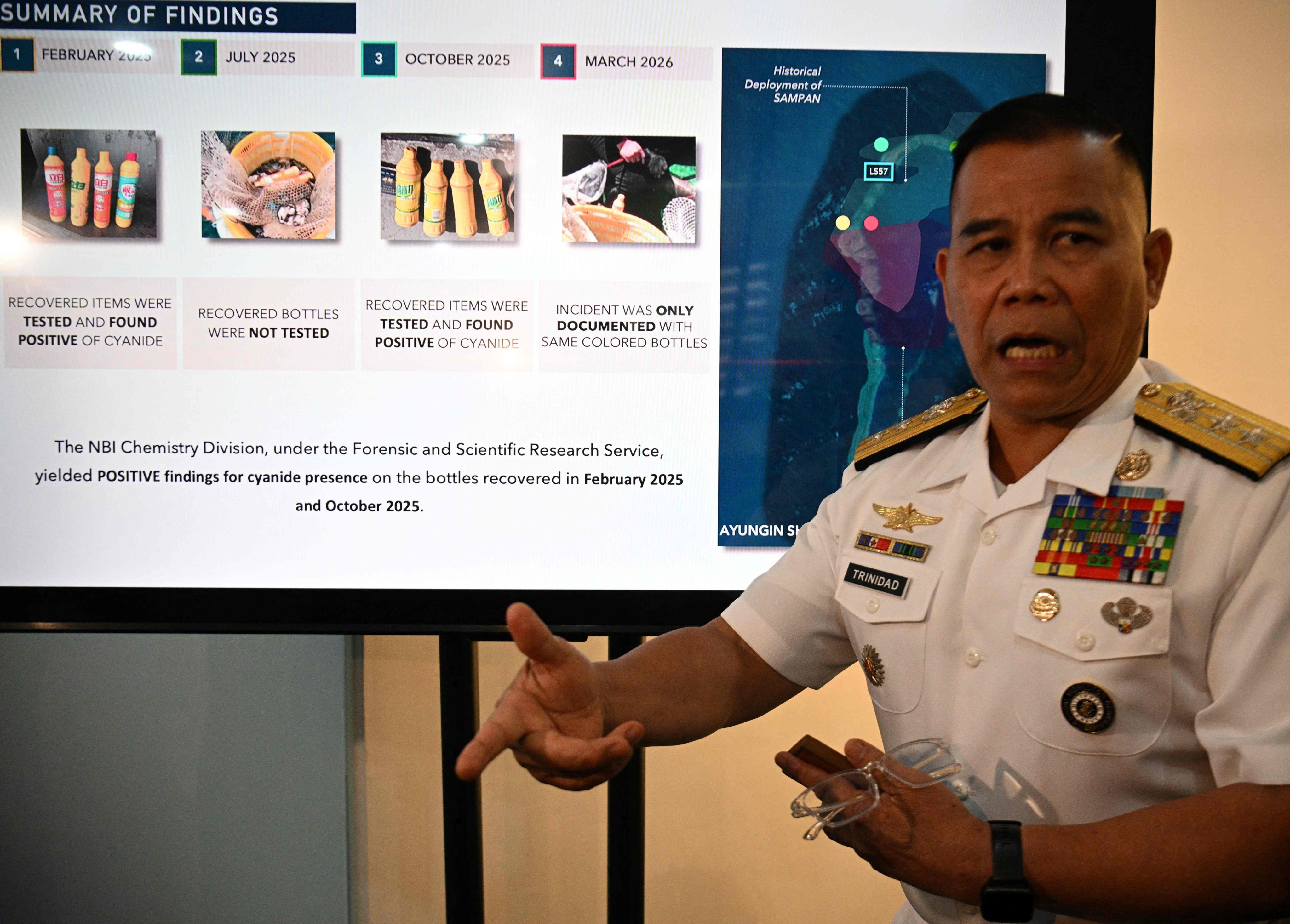 Philippine Navy spokesman Rear Admiral Roy Vincent Trinidad speaks next to a slide presentation of seized yellow bottles suspected to contain cyanide in waters of Second Thomas Shoal in the disputed South China Sea, during a press conference in Manila on Monday. Photo: AFP