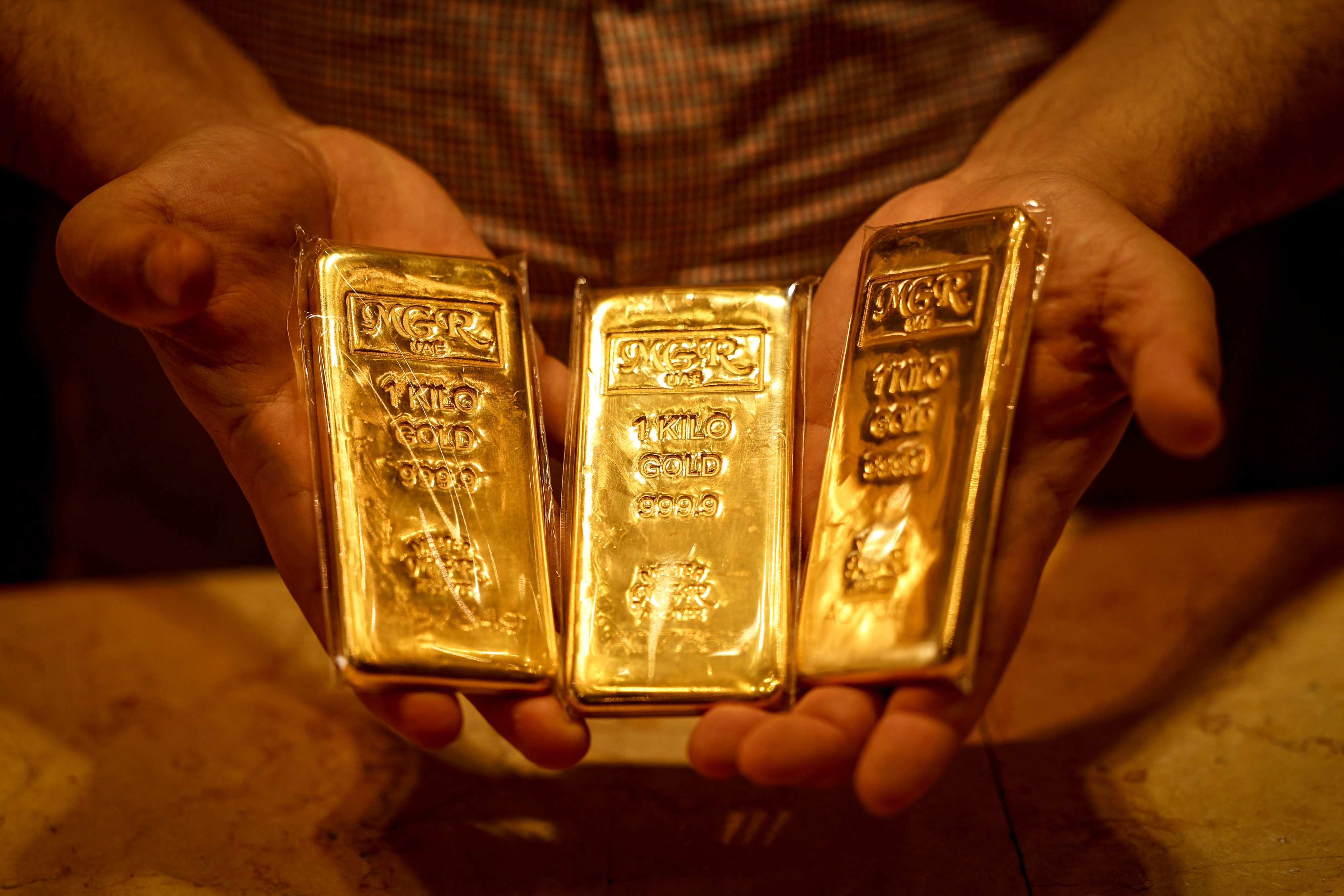 A dealer displays gold bars in a shop in Dubai’s Gold Souk on April 13. Photo: AFP