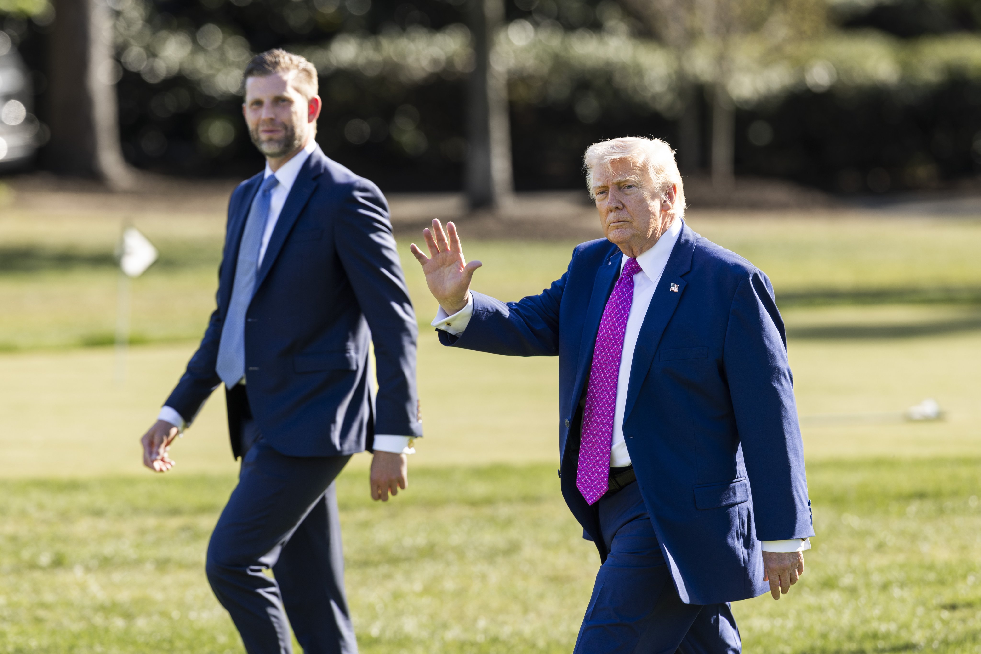 US President Donald Trump (right) and his son Eric Trump leave the White House in Washington on Friday. Photo: EPA
