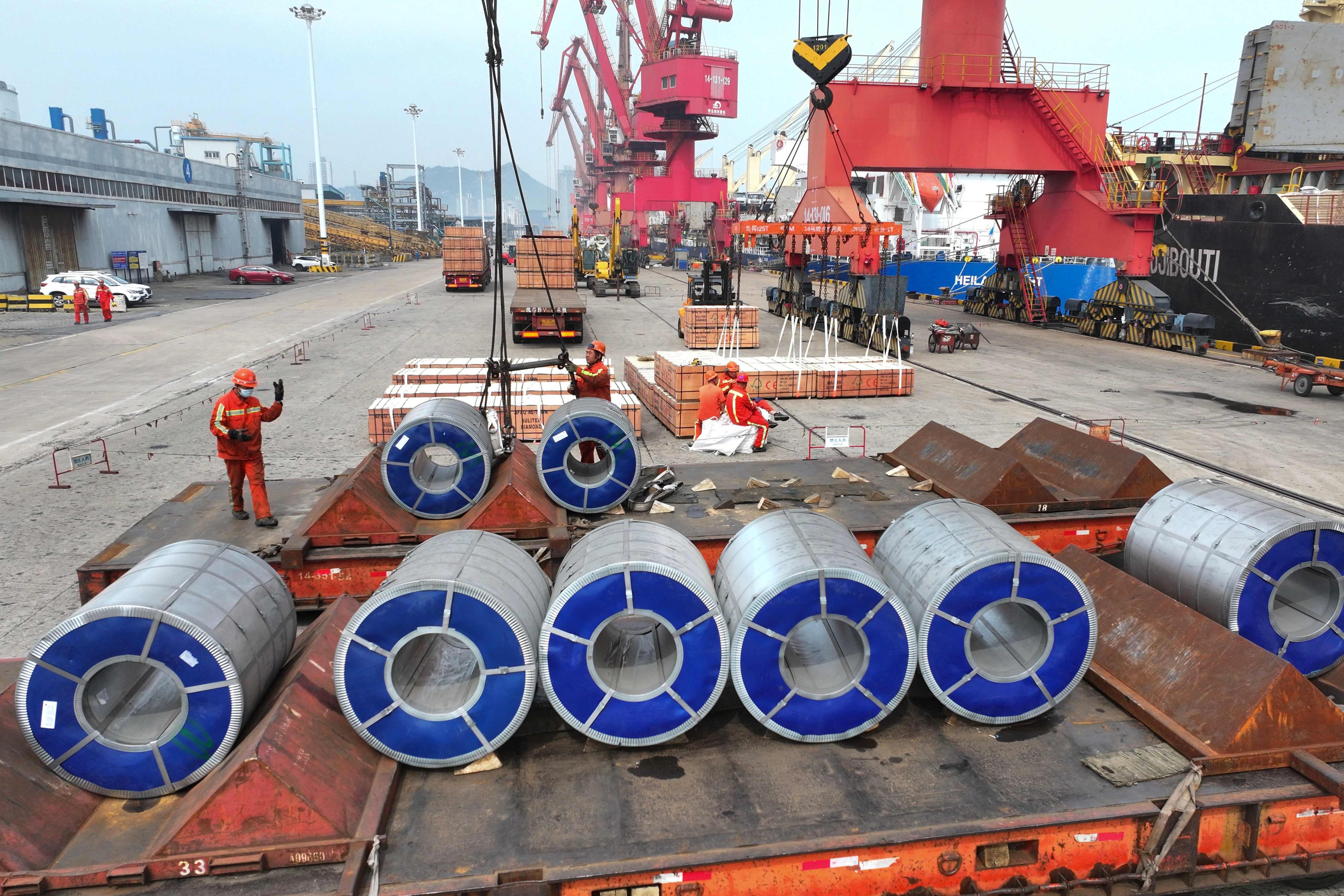 Workers prepare steel coils for shipment at Lianyungang Port, in Jiangsu province, on Saturday. Photo: AFP
