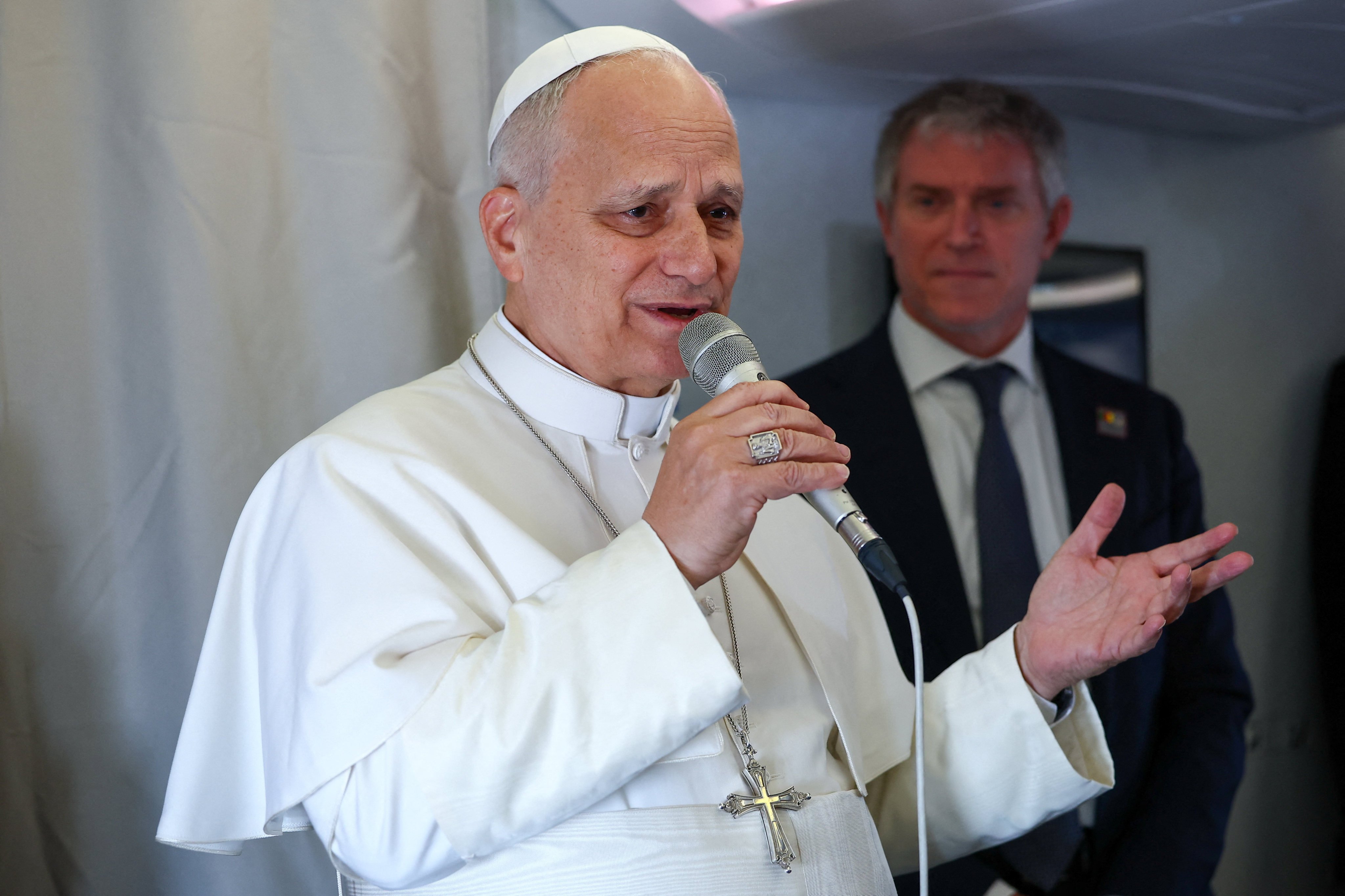 Pope Leo speaks to members of the media on board a plane on Wednesday en route to Yaounde, Cameroon, amid his apostolic journey. Photo: Reuters