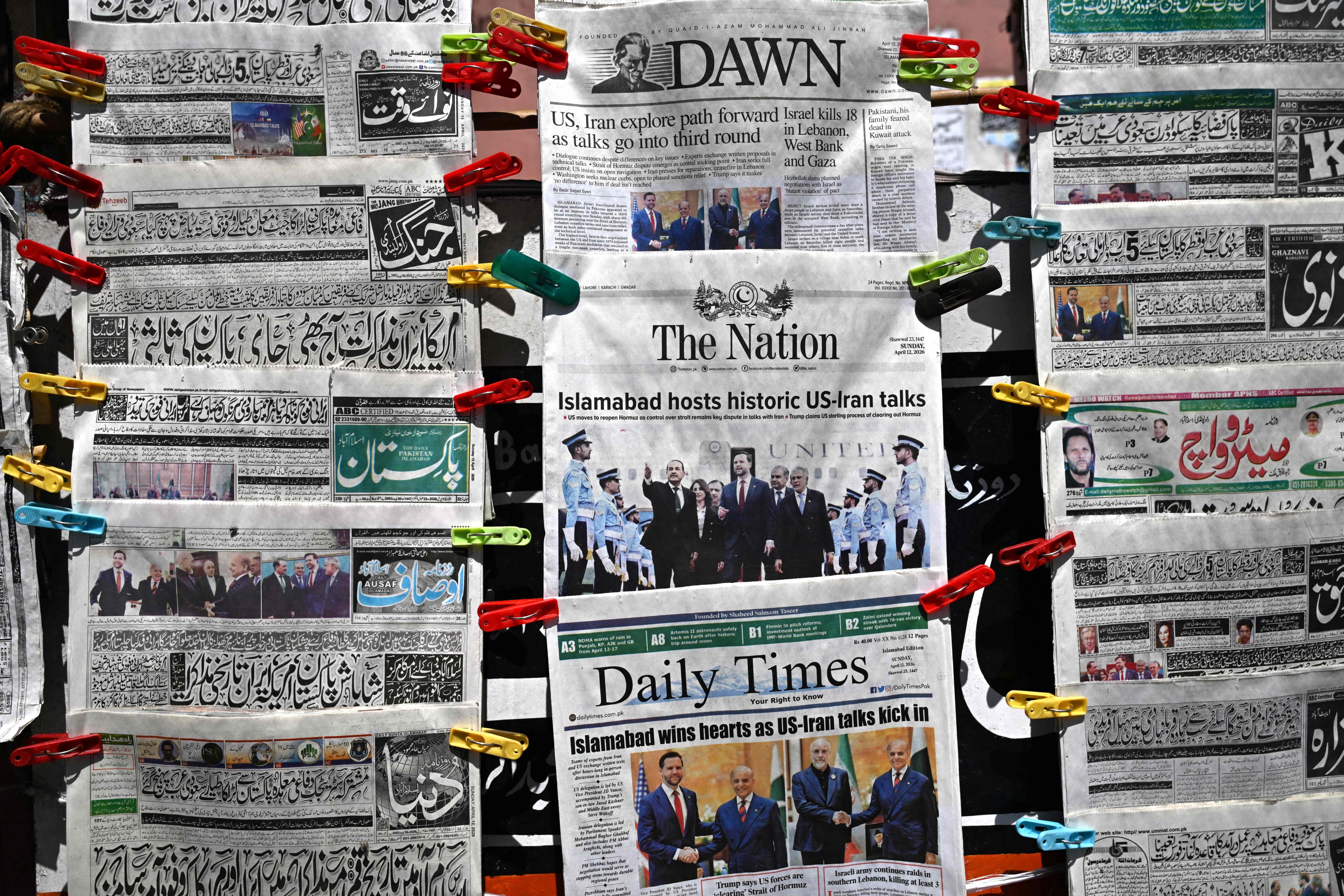 English and Urdu newspapers at a roadside stall after the US-Iran peace talks in Islamabad on April 12. Photo: AFP