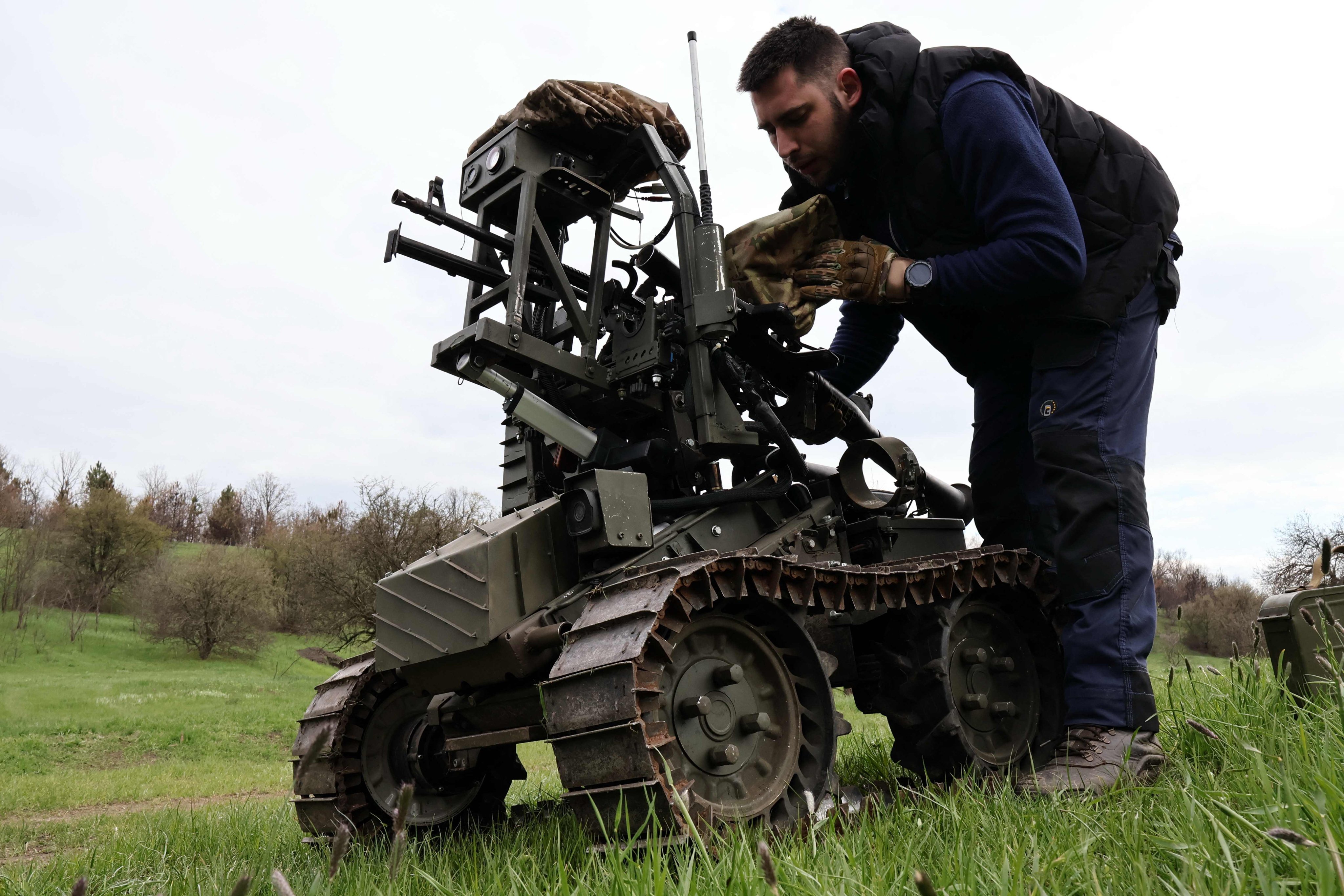A Ukrainian serviceman prepares a machine gun on a combat ground drone during a training at an undisclosed location in the Zaporizhzhia region. Photo: 65th Mechanized Brigade of Ukrainian Armed Forces via AFP