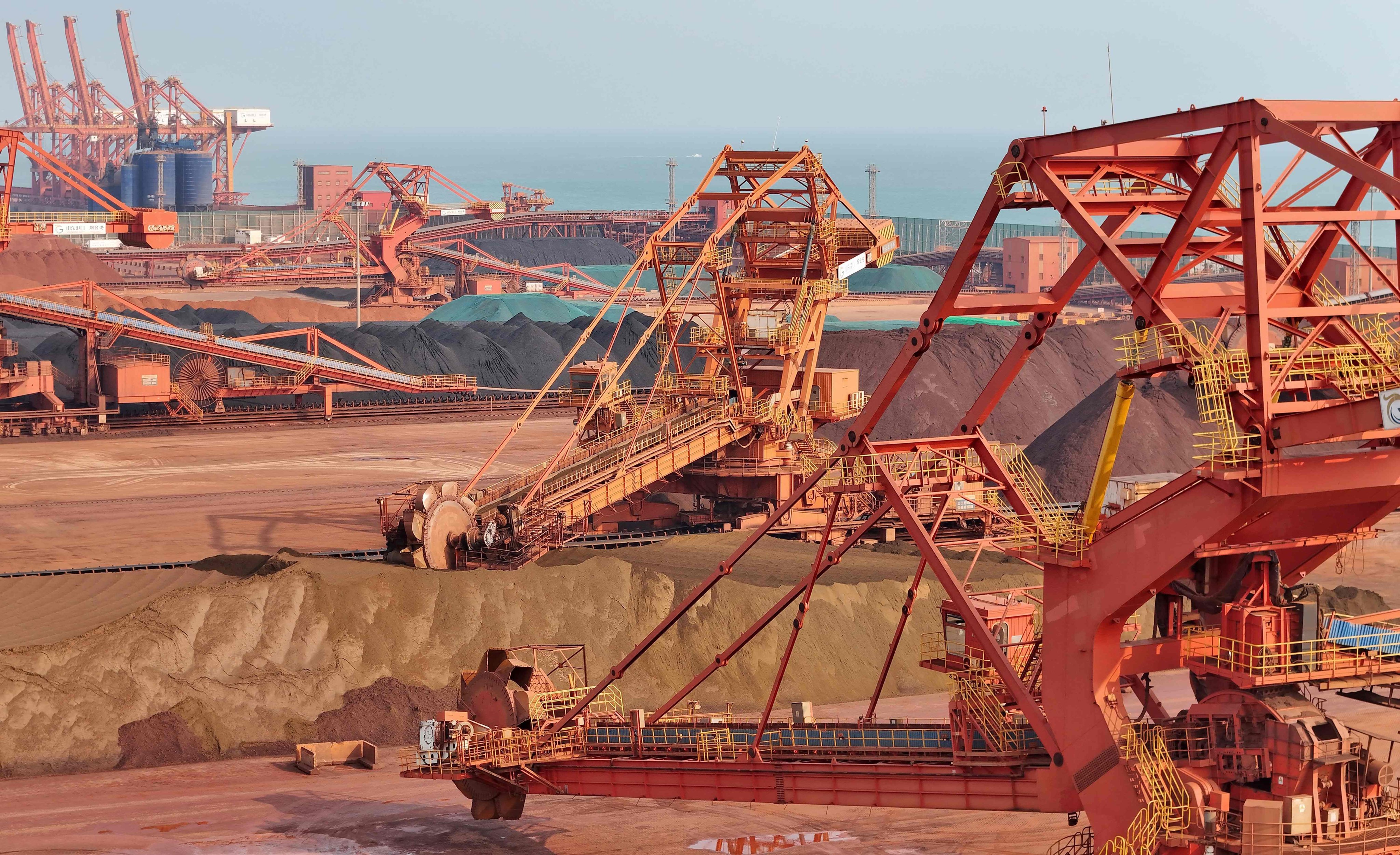 Heavy machinery handling bauxite and iron ore is seen in China’s eastern Shandong province. Photo: AFP