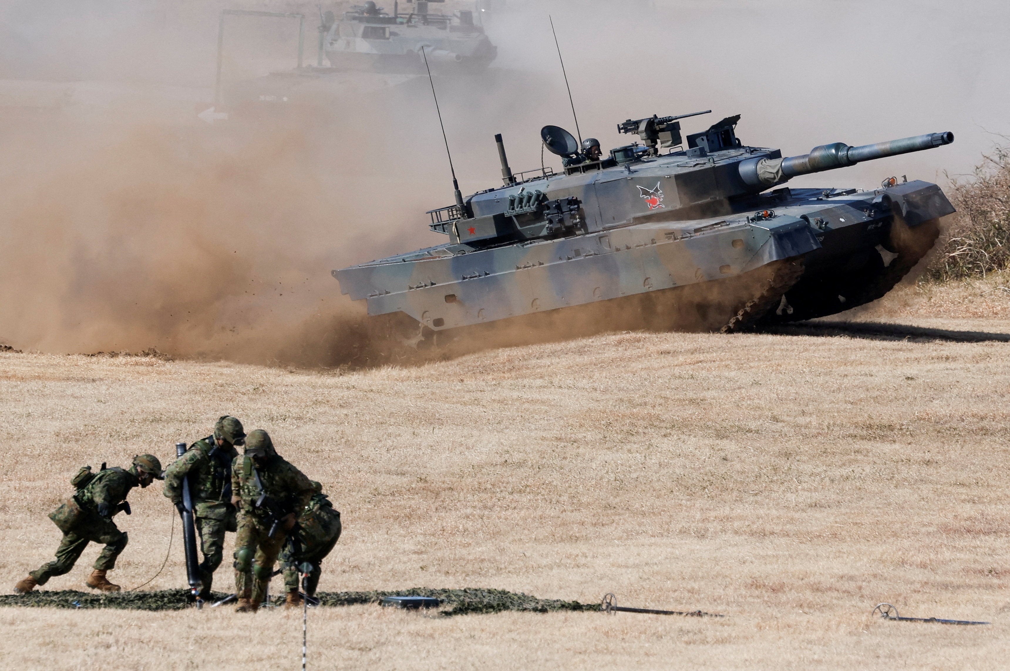 Japanese Type 10 battle tanks operate during a military drill in Funabashi, east of Tokyo, in January. Photo: Reuters