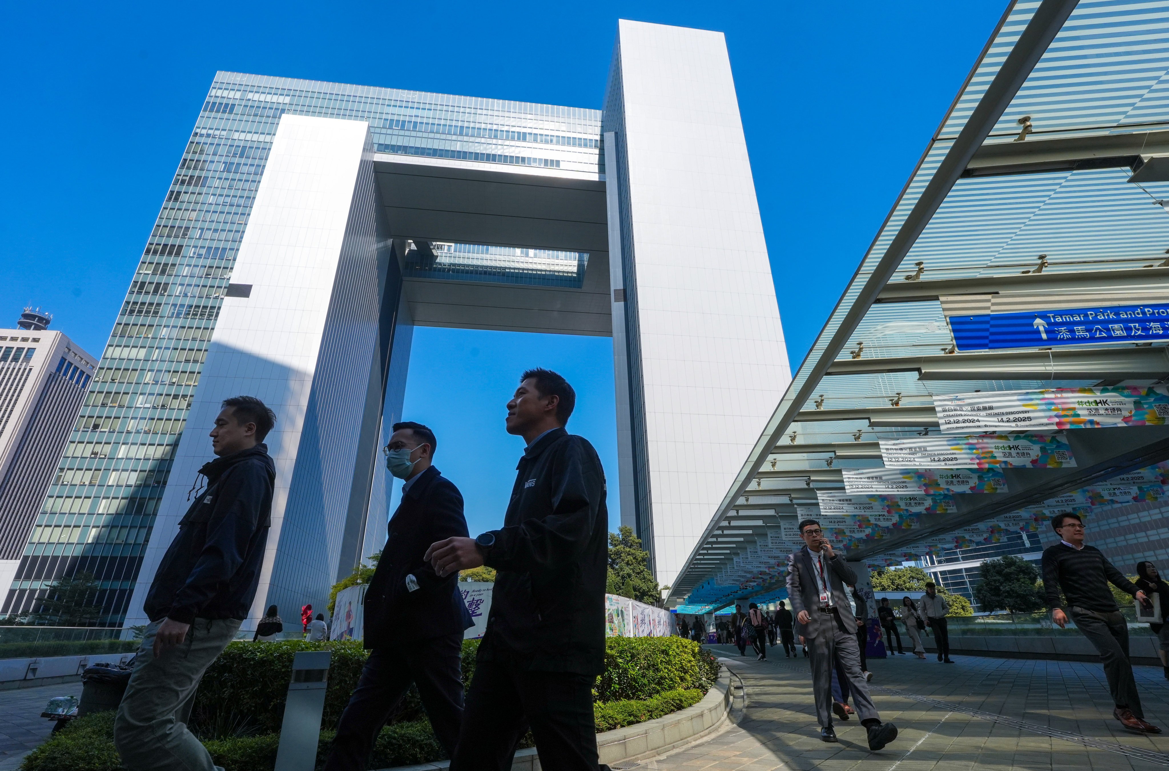 People walk past the government headquarters in Tamar, Admiralty in December 2024. Photo: Sun Yeung