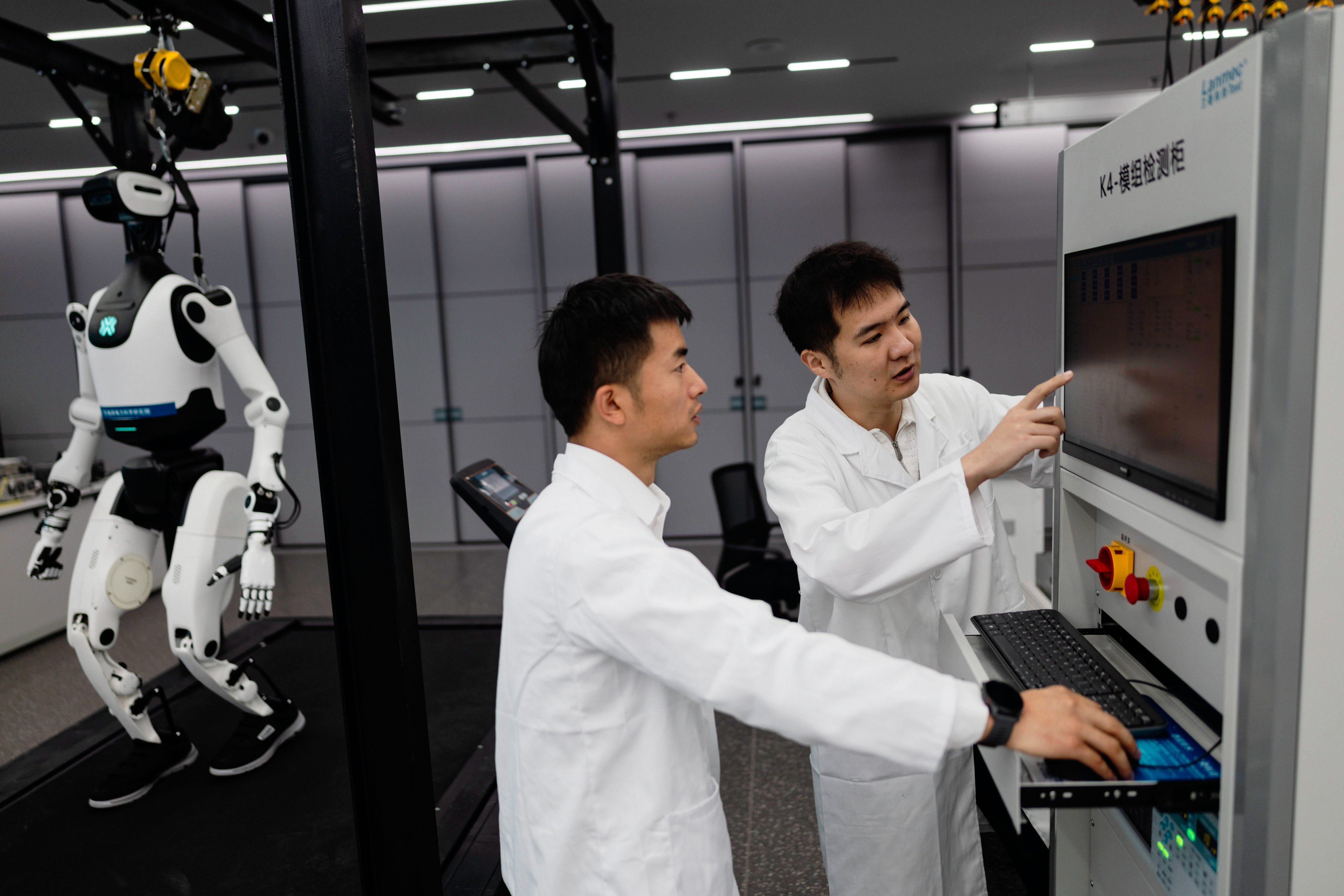 Employees train AI service robots in a Southern Power Grid company laboratory in Guangzhou, Guangdong province, China, on Thursday. Photo: EPA-EFE